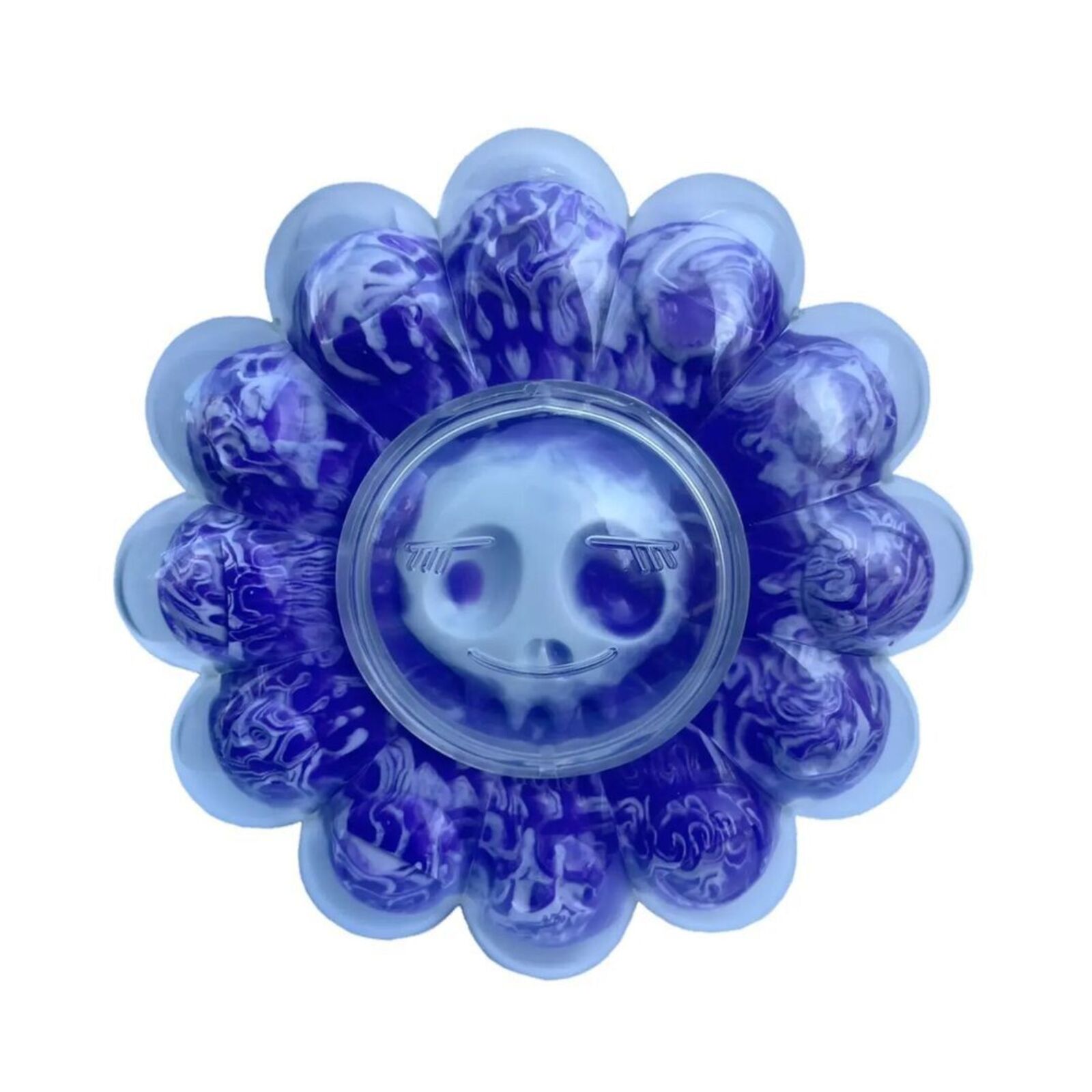 A box of purple and blue flowers with a skull in it.