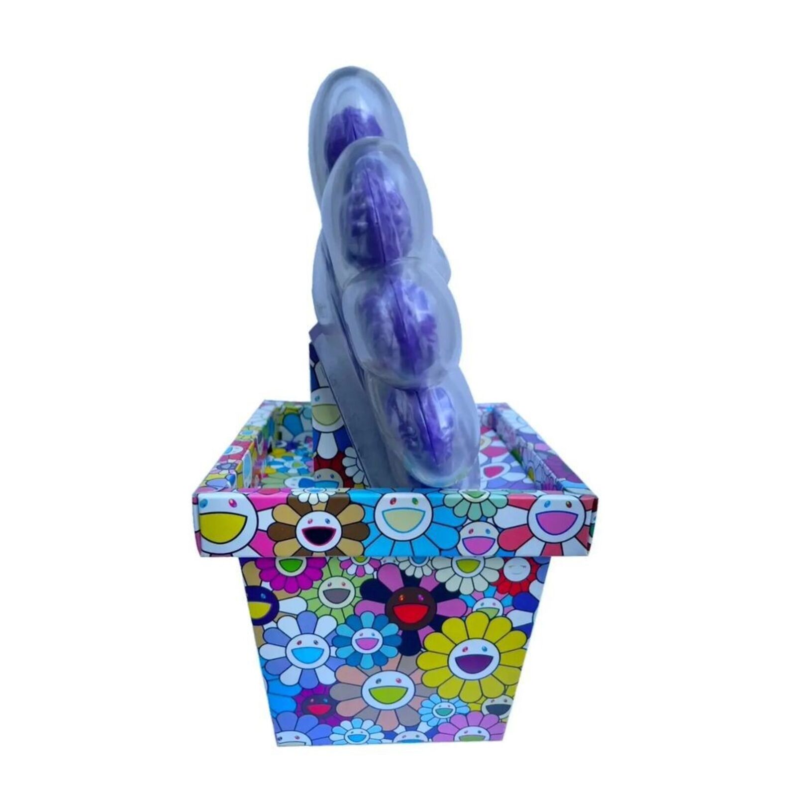 A box of purple and blue flowers with a skull in it.