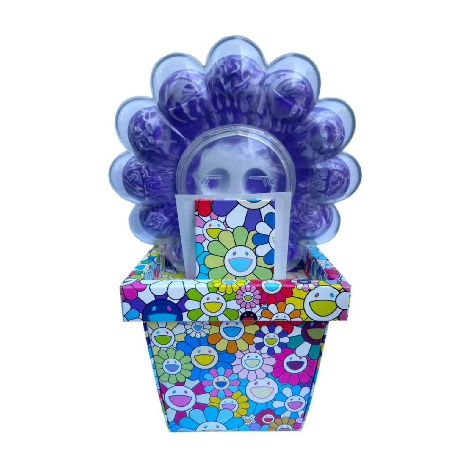 A box of purple and blue flowers with a skull in it.