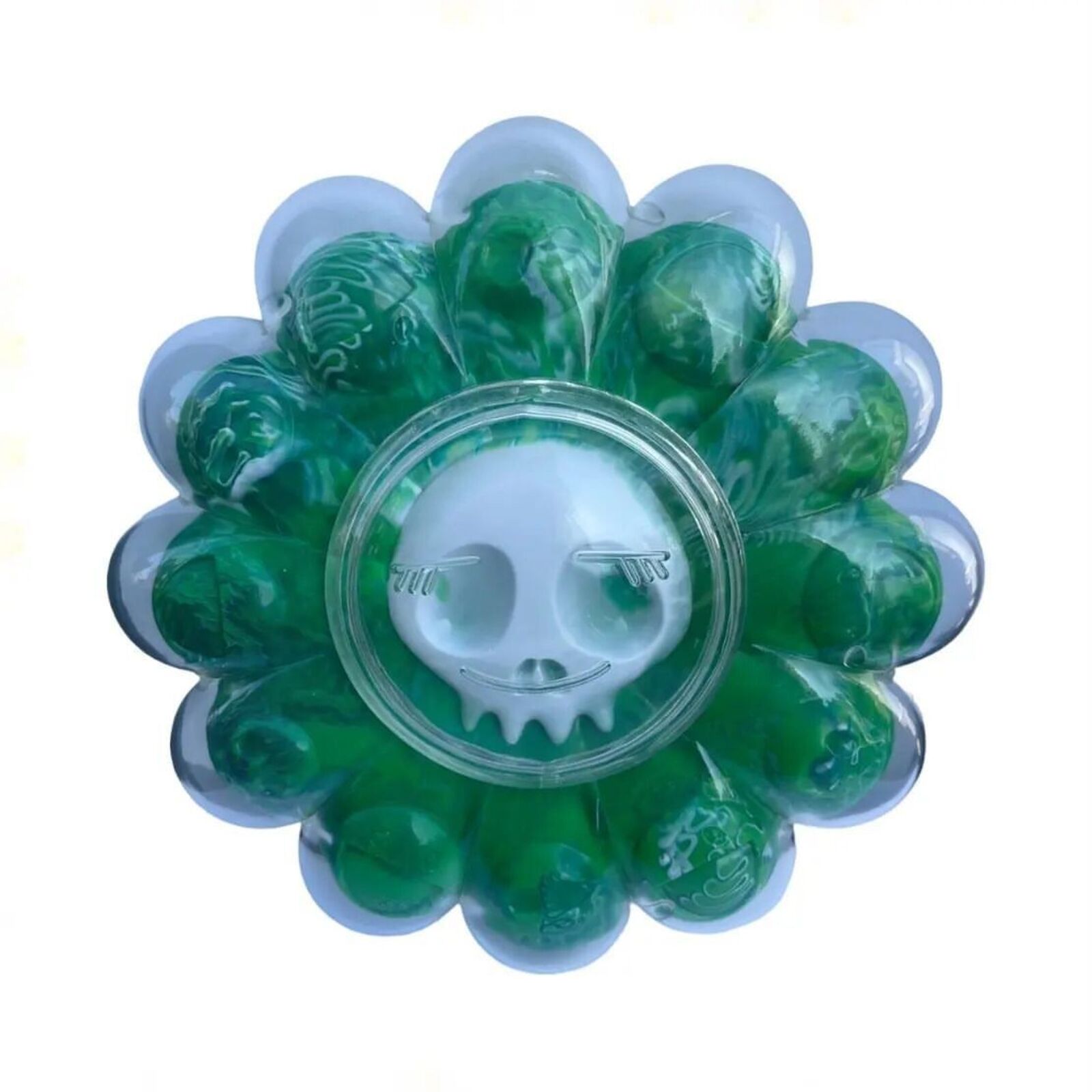 A flower shaped container filled with green gummy bears in it.