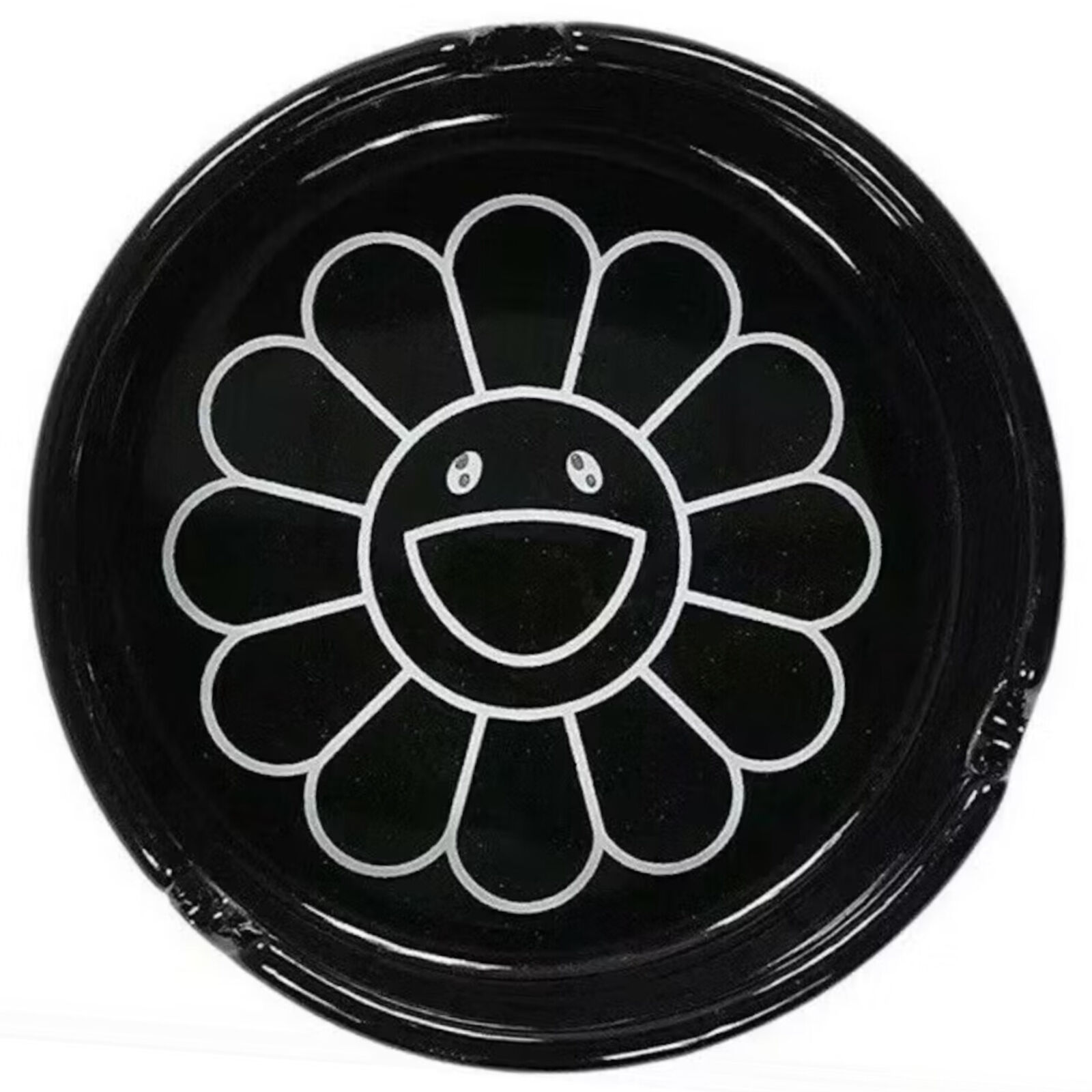 A black plate with a smiley face drawn on it.