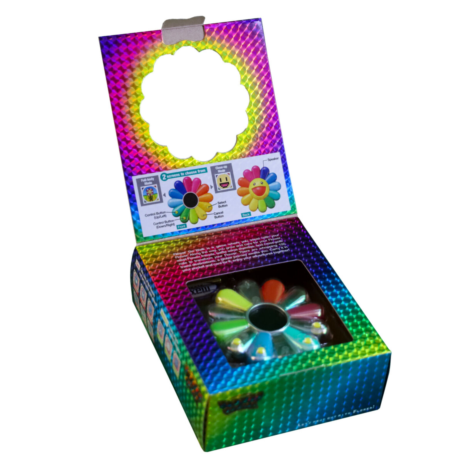 A colorful flower shaped keychain with a smiley face on it.