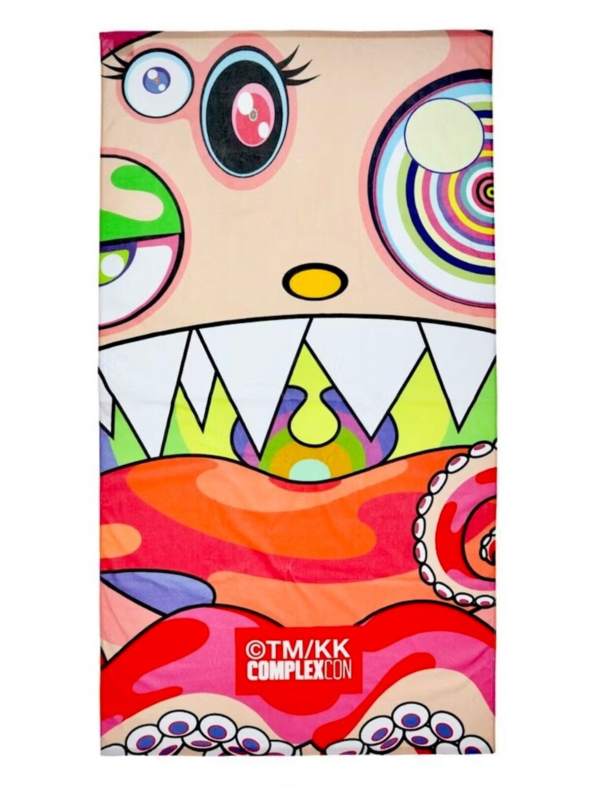 A colorful towel with a cartoon monster face on it.