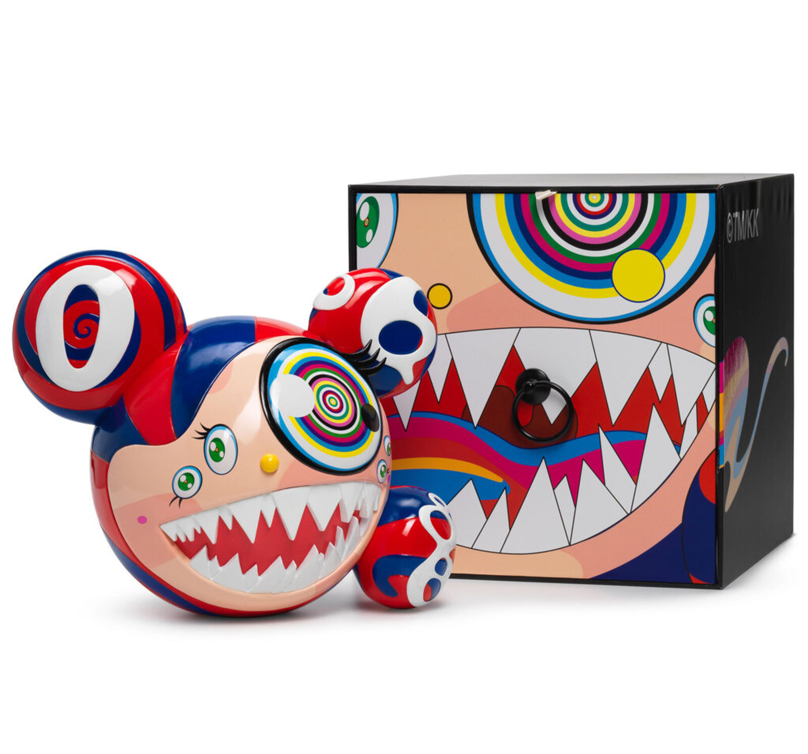 A colorful, cartoonish figure with a large mouth and spiral eye sits beside its matching box.