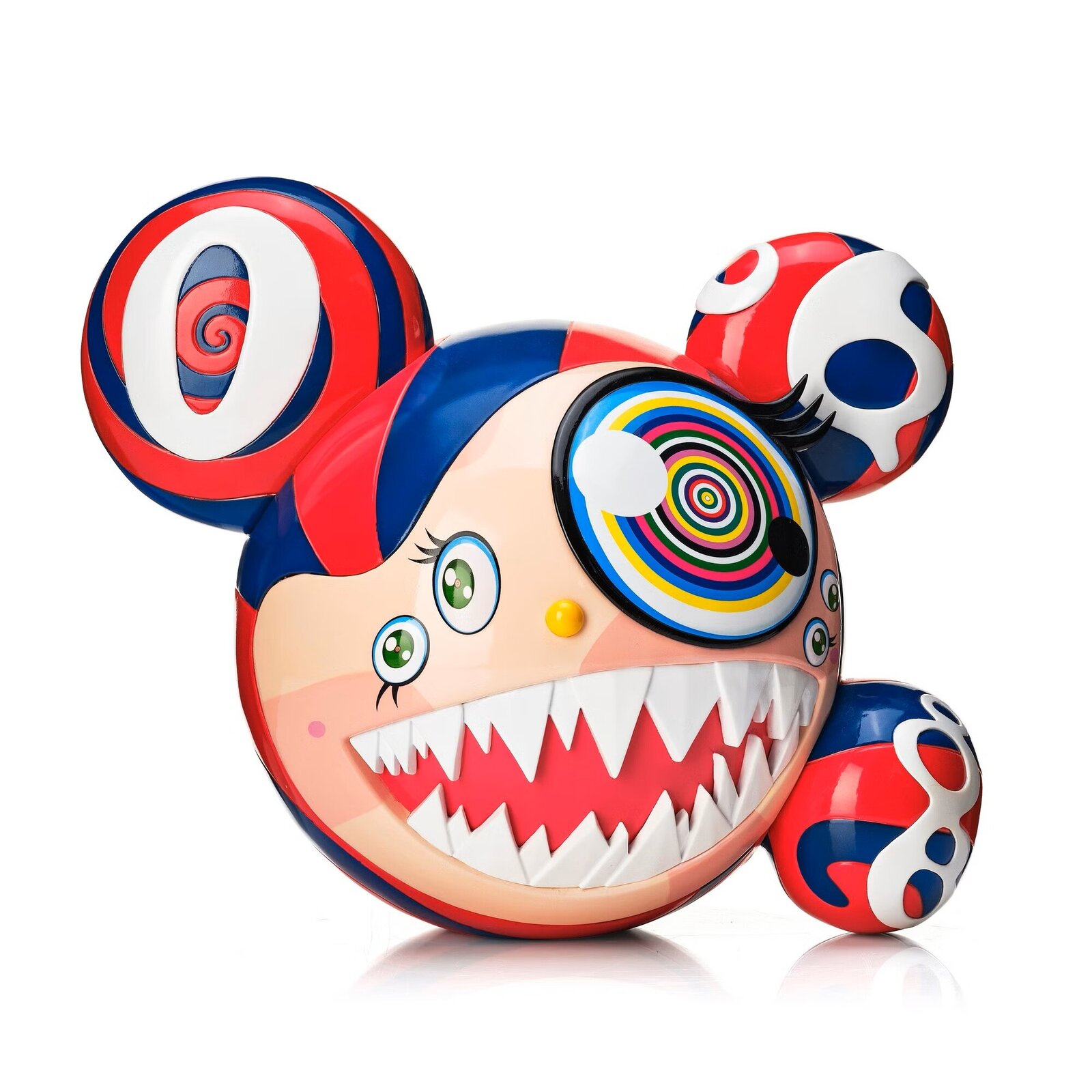 A colorful, cartoonish figure with a large mouth and spiral eye sits beside its matching box.