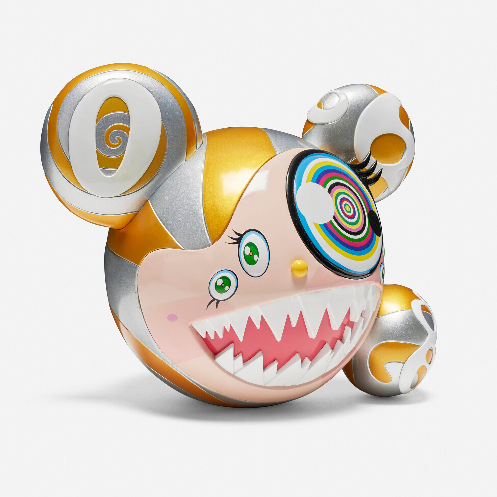 A colorful, stylized figure with a wide grin and spiral eyes sits beside its matching box.