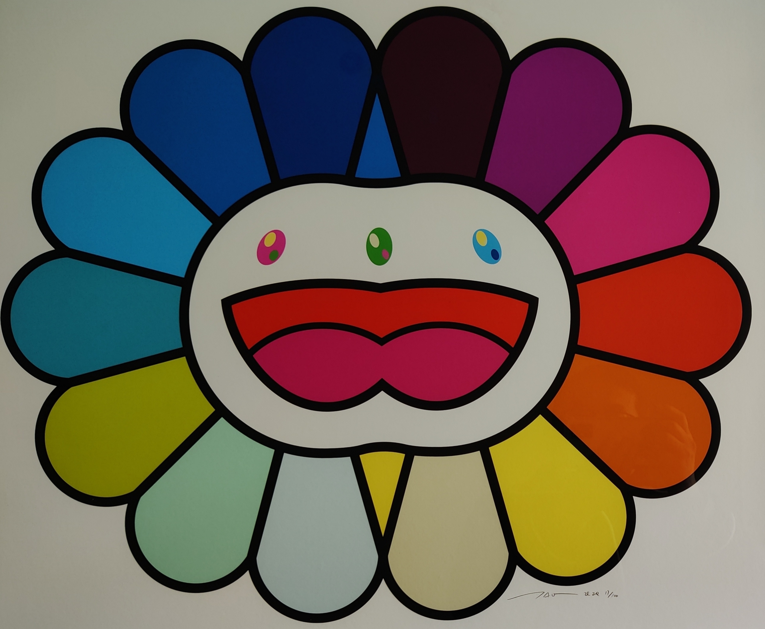 A colorful, stylized flower-like face with a rainbow of petals and a wide, open mouth.