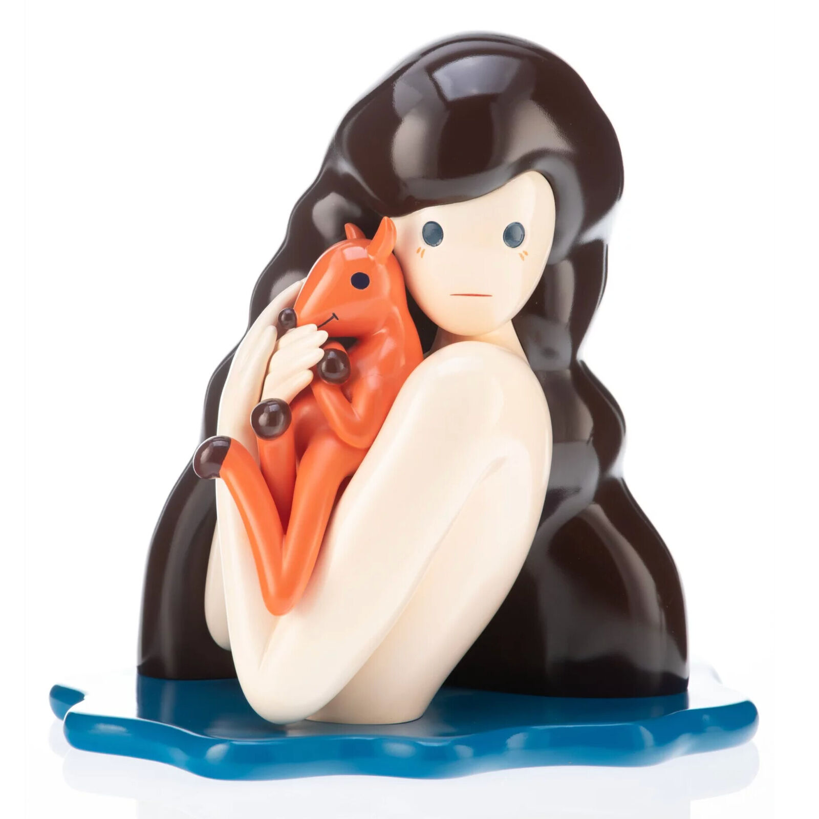 A figurine of a woman holding a fox in her arms.