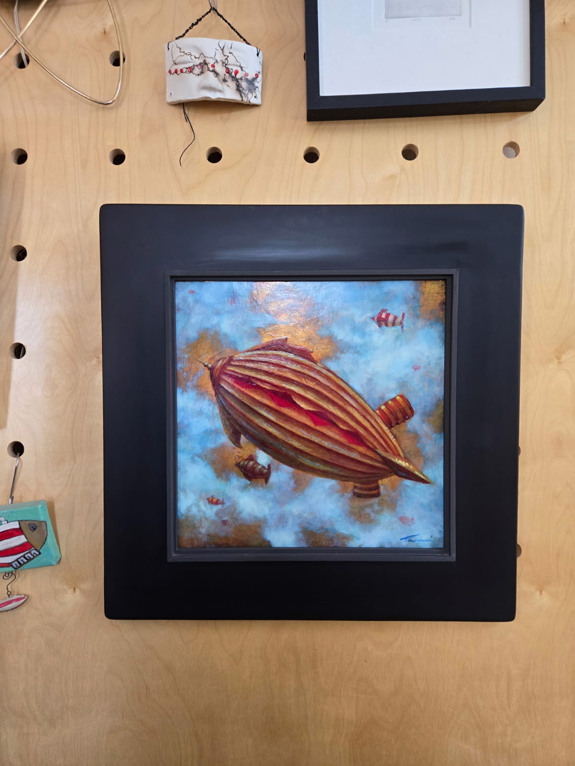 A painting of an airship flying through the sky with fish in the background.