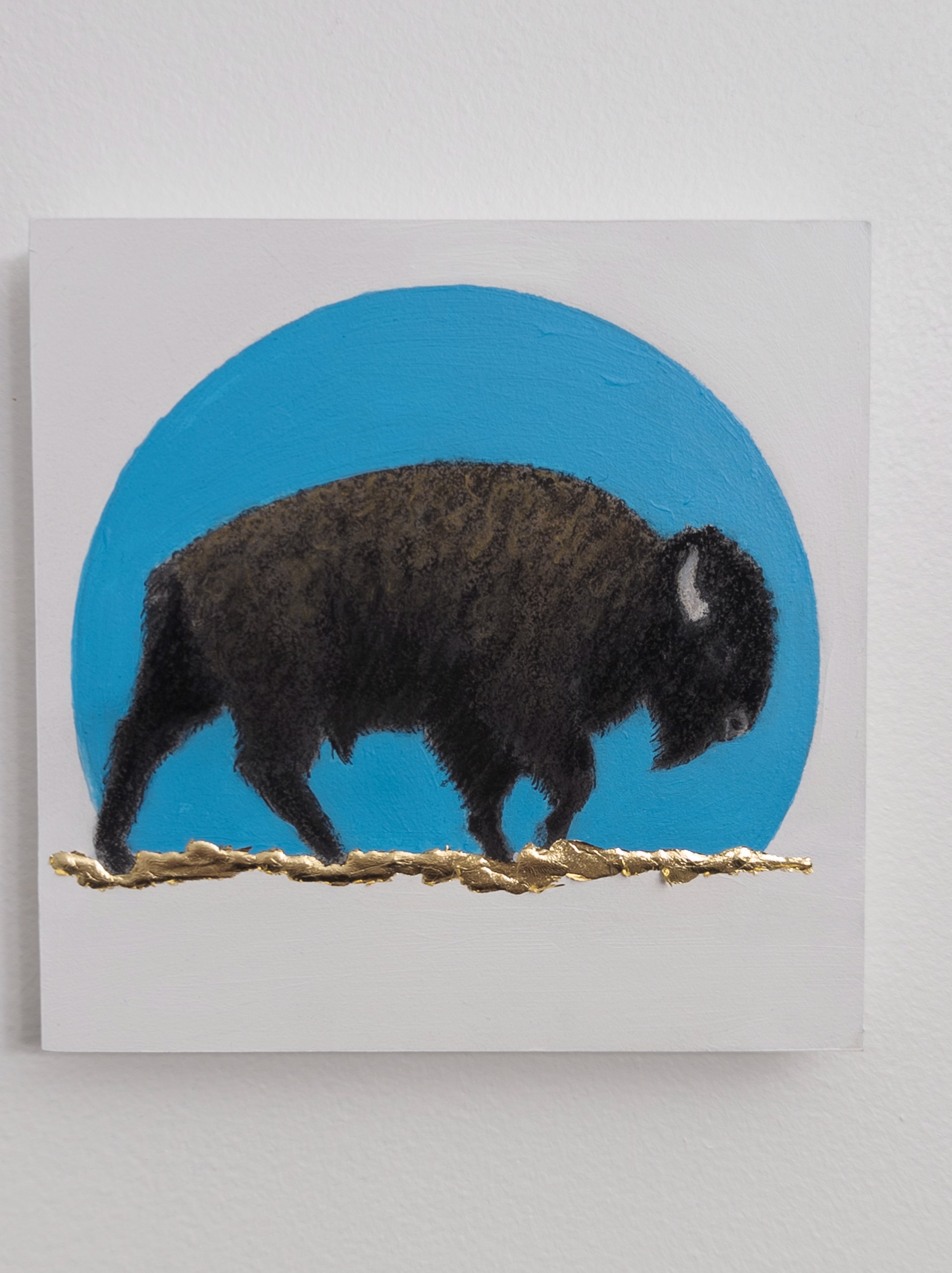 A painting of a bison standing in front of a blue circle.