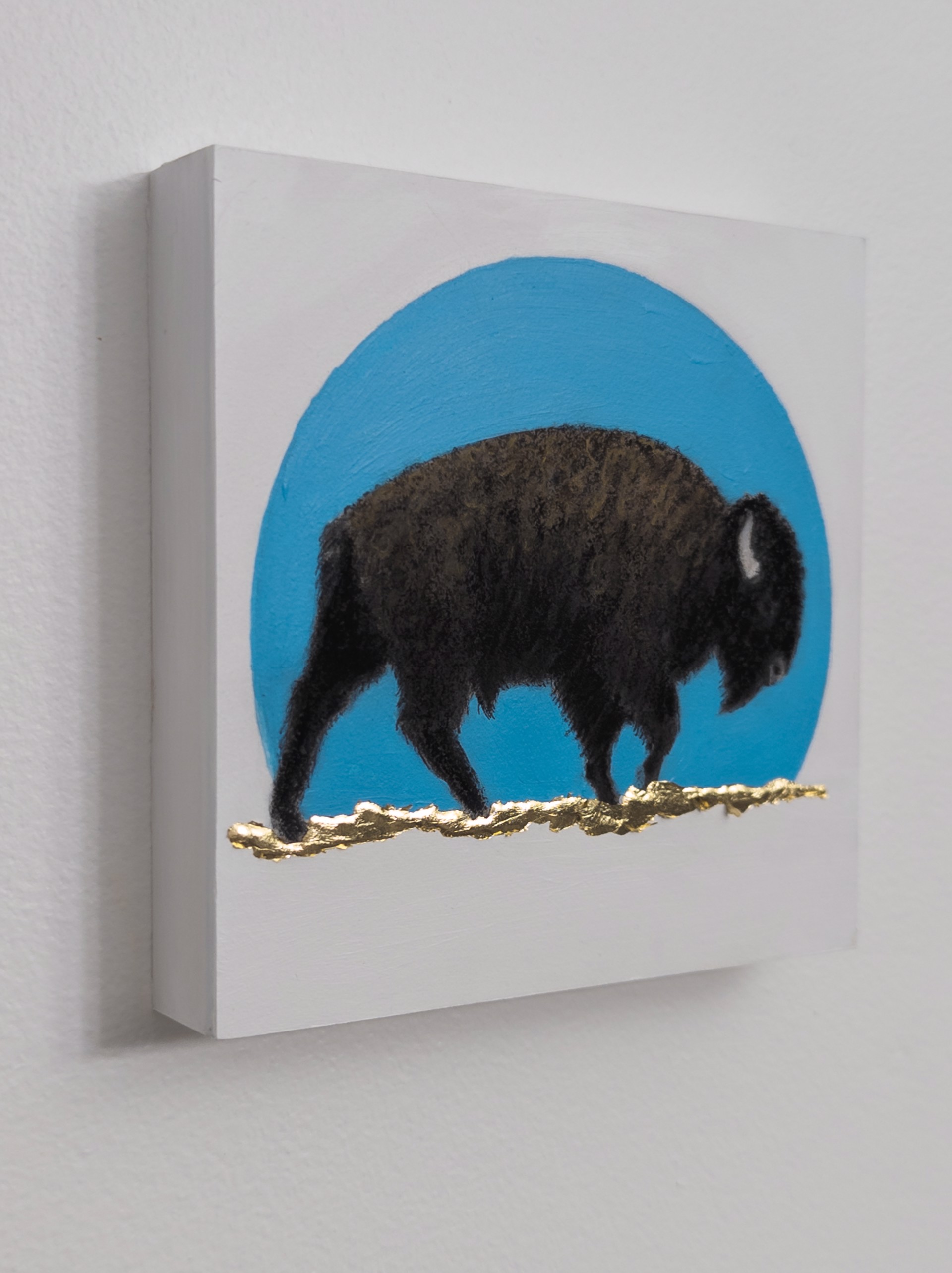 A painting of a bison standing in front of a blue circle.