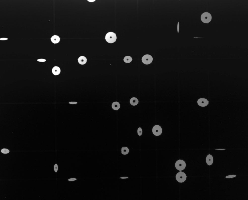 A black and white photo of a black background with white dots.