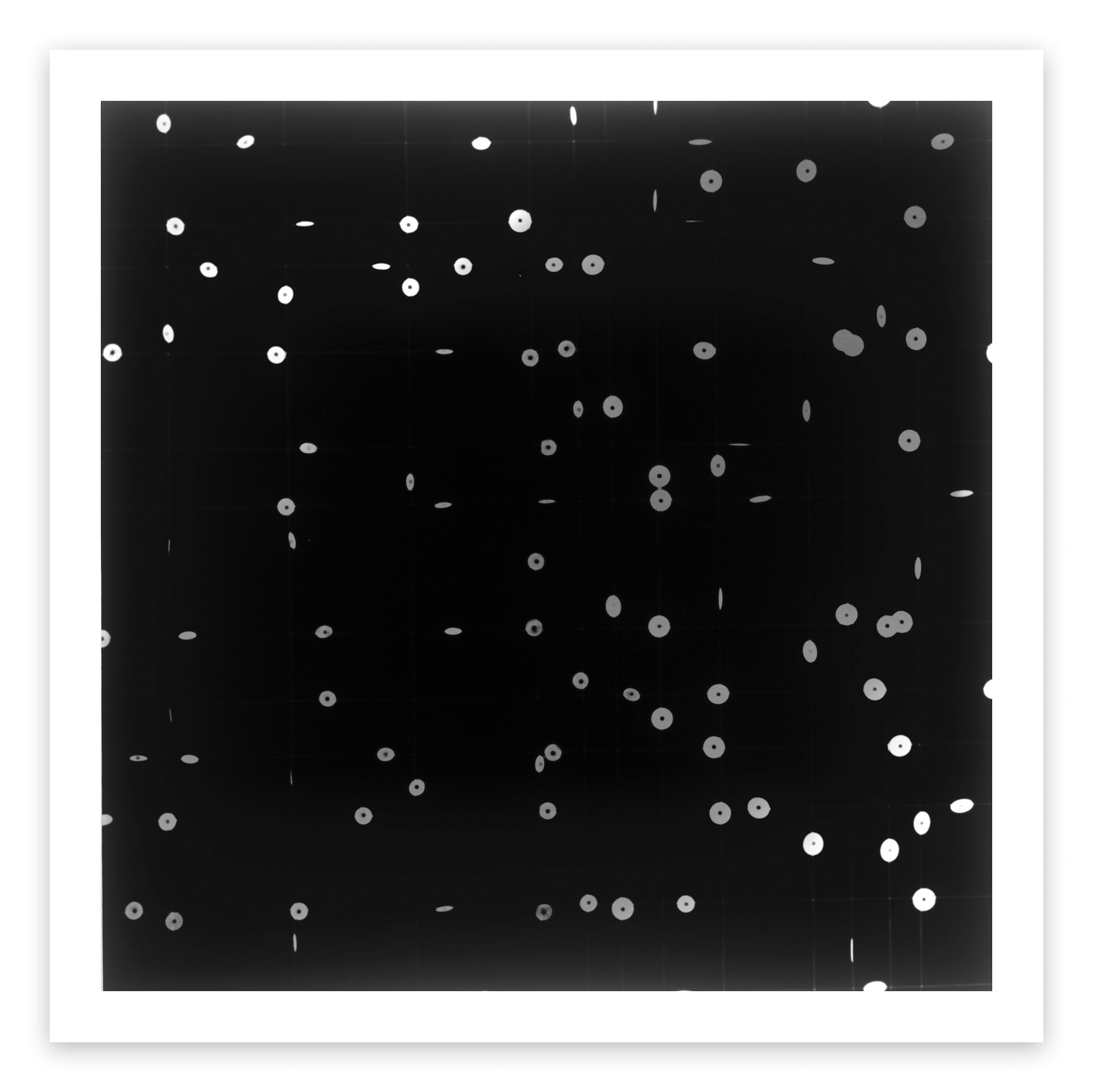 A black and white photo of a black background with white dots.