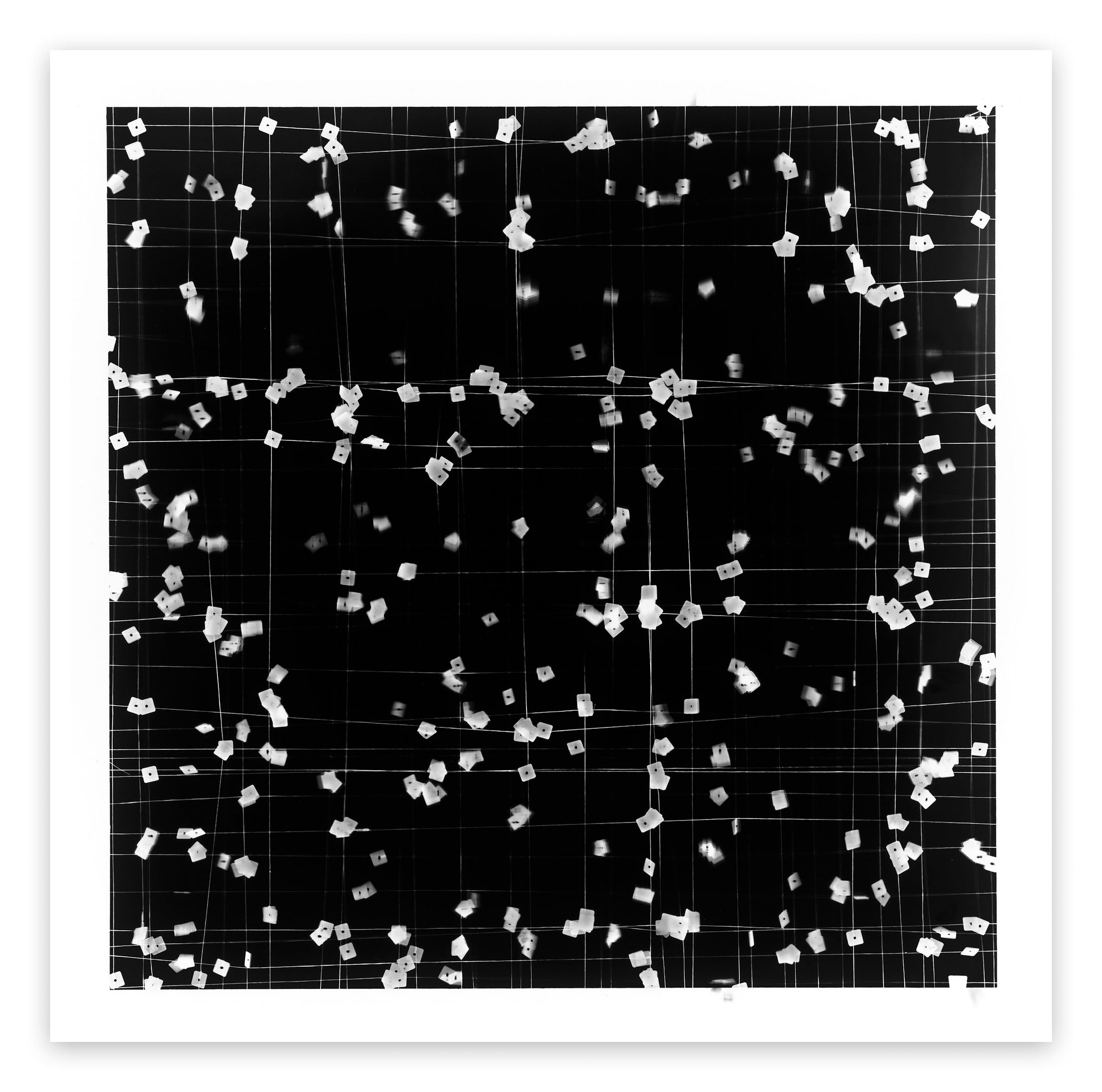 A black and white photo of confetti falling from the ceiling.