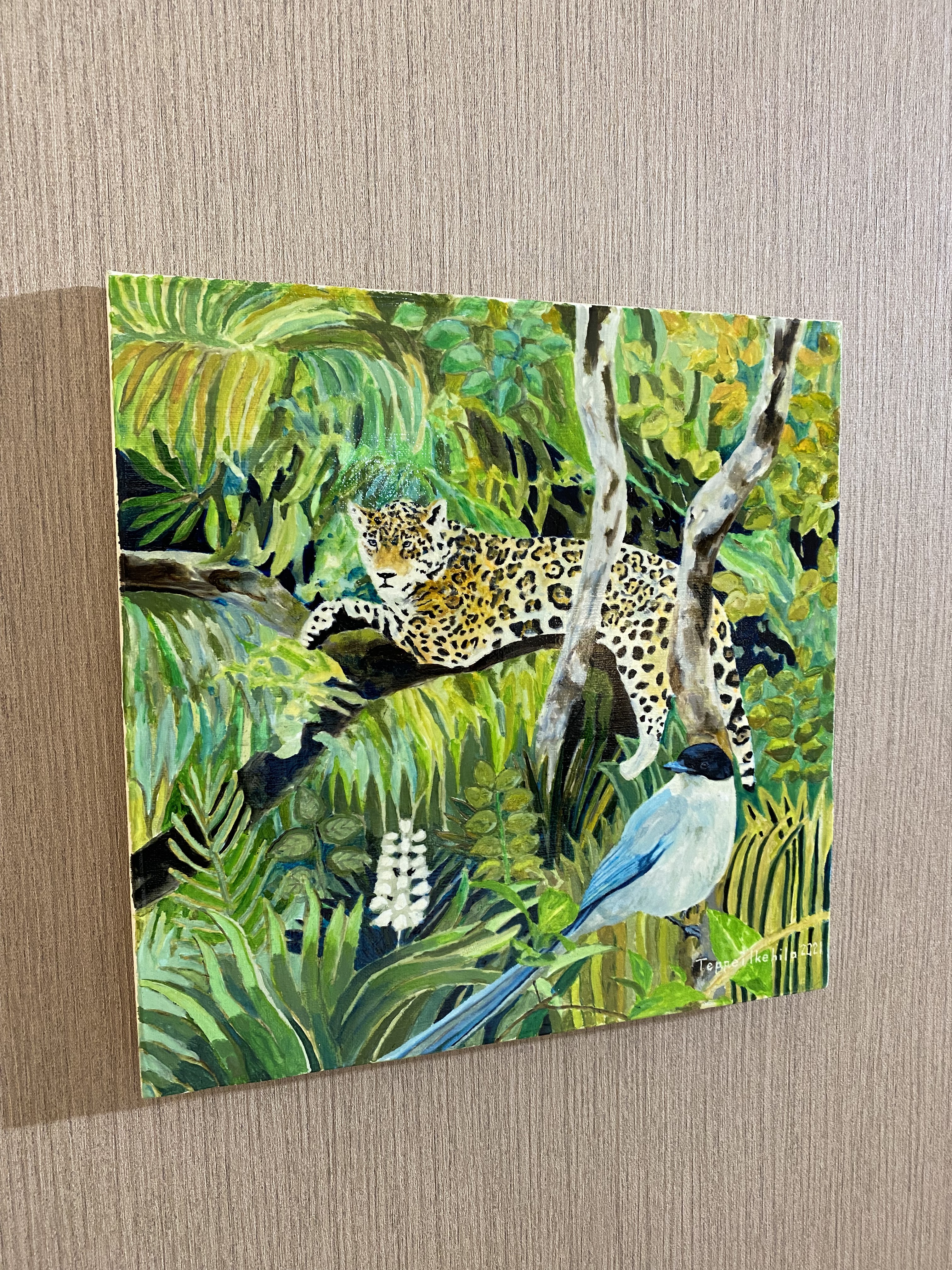 A vibrant painting of a spotted feline resting on a branch above a blue bird in a lush jungle.