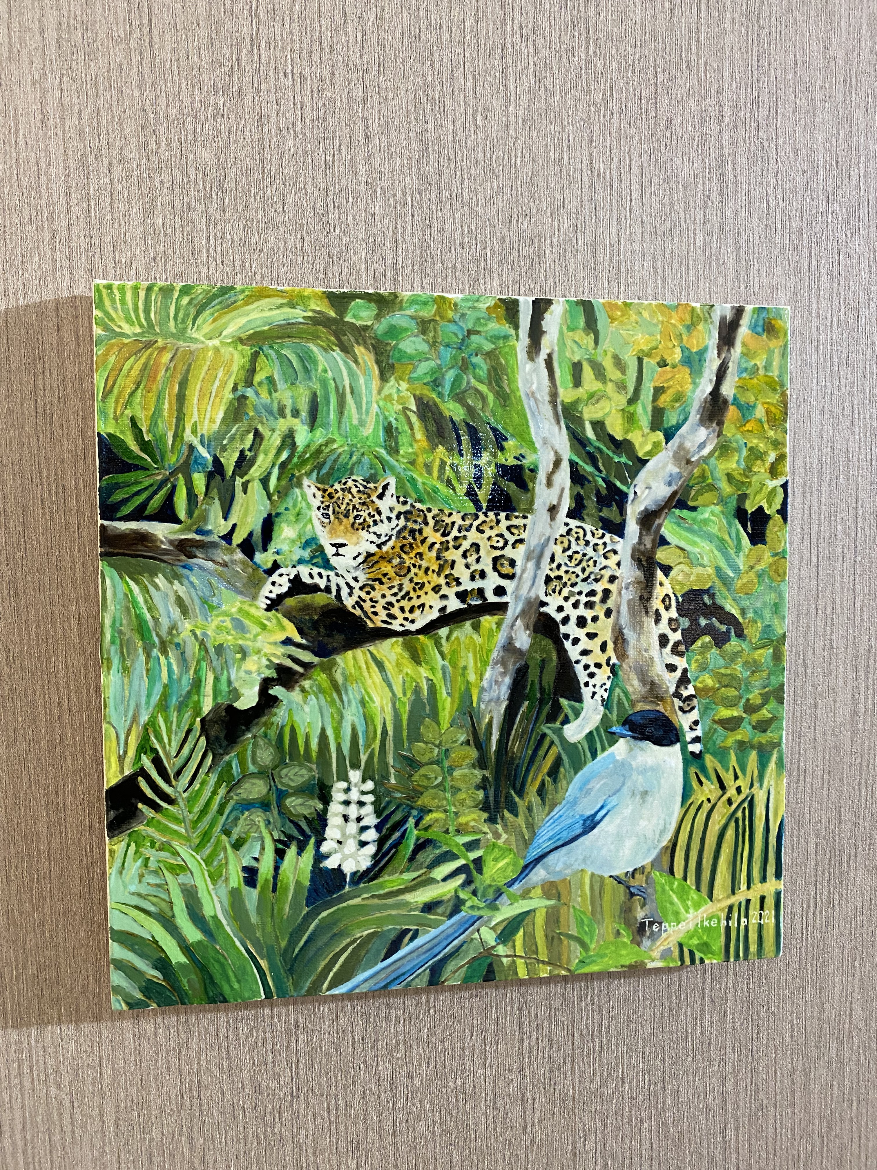 A vibrant painting of a spotted feline resting on a branch above a blue bird in a lush jungle.