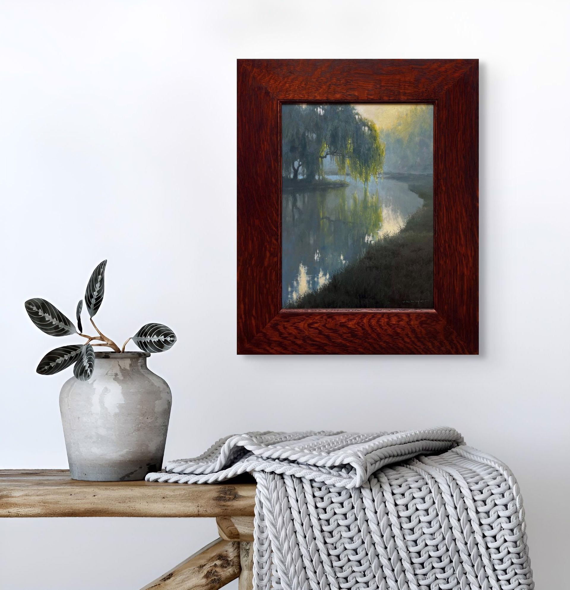 A misty river scene with a weeping willow tree reflecting in calm water under soft morning light.