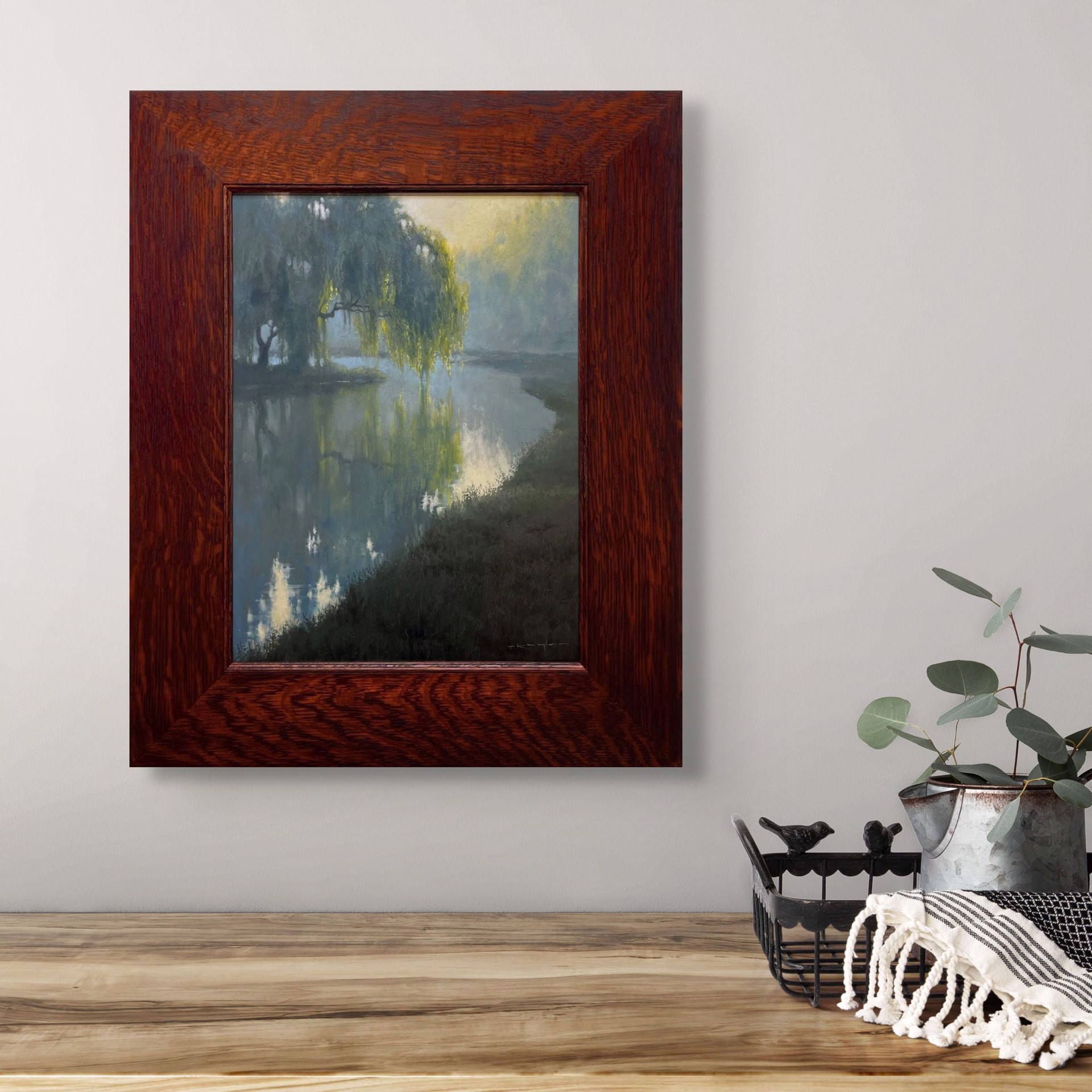 A misty river scene with a weeping willow tree reflecting in calm water under soft morning light.