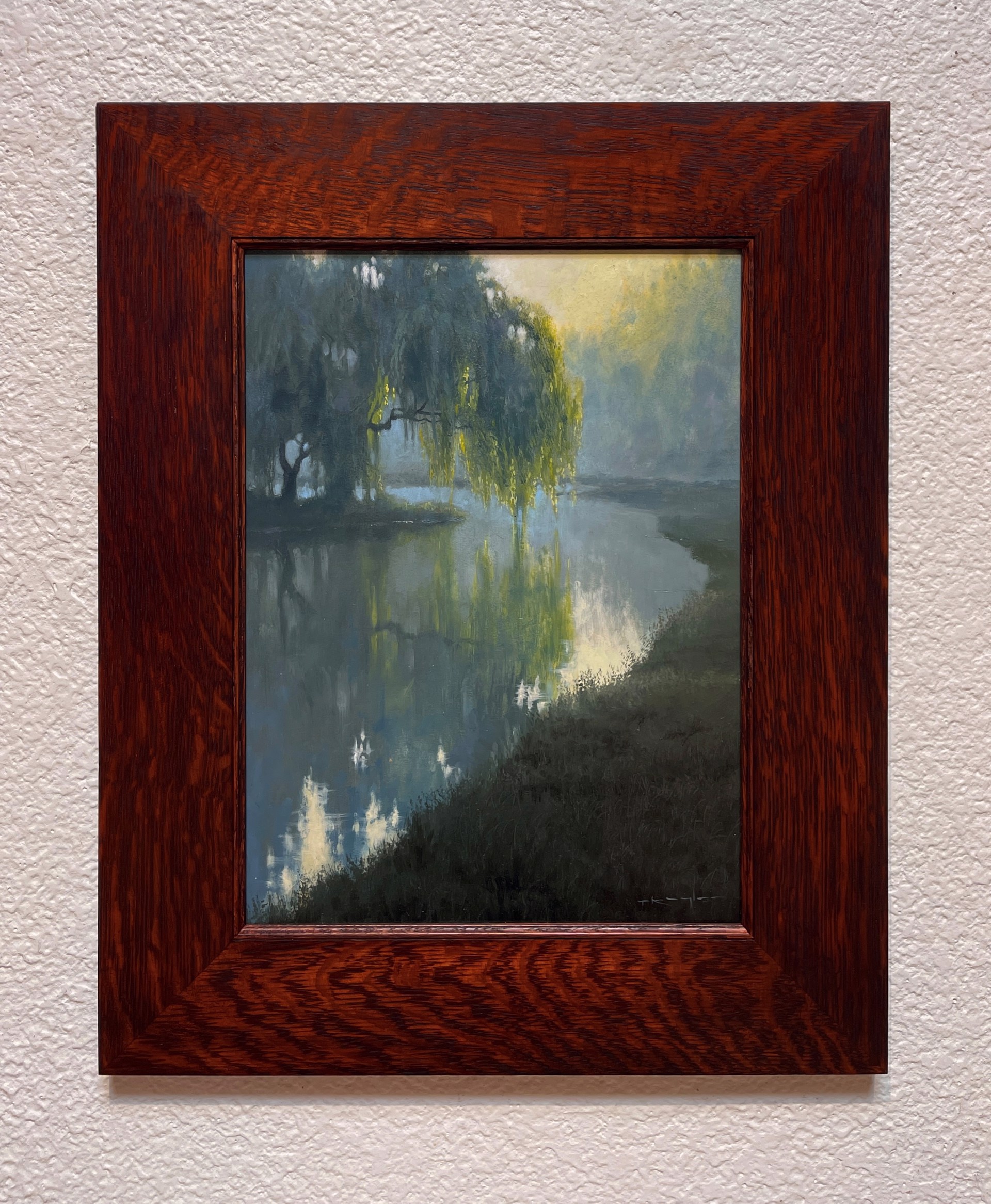 A misty river scene with a weeping willow tree reflecting in calm water under soft morning light.