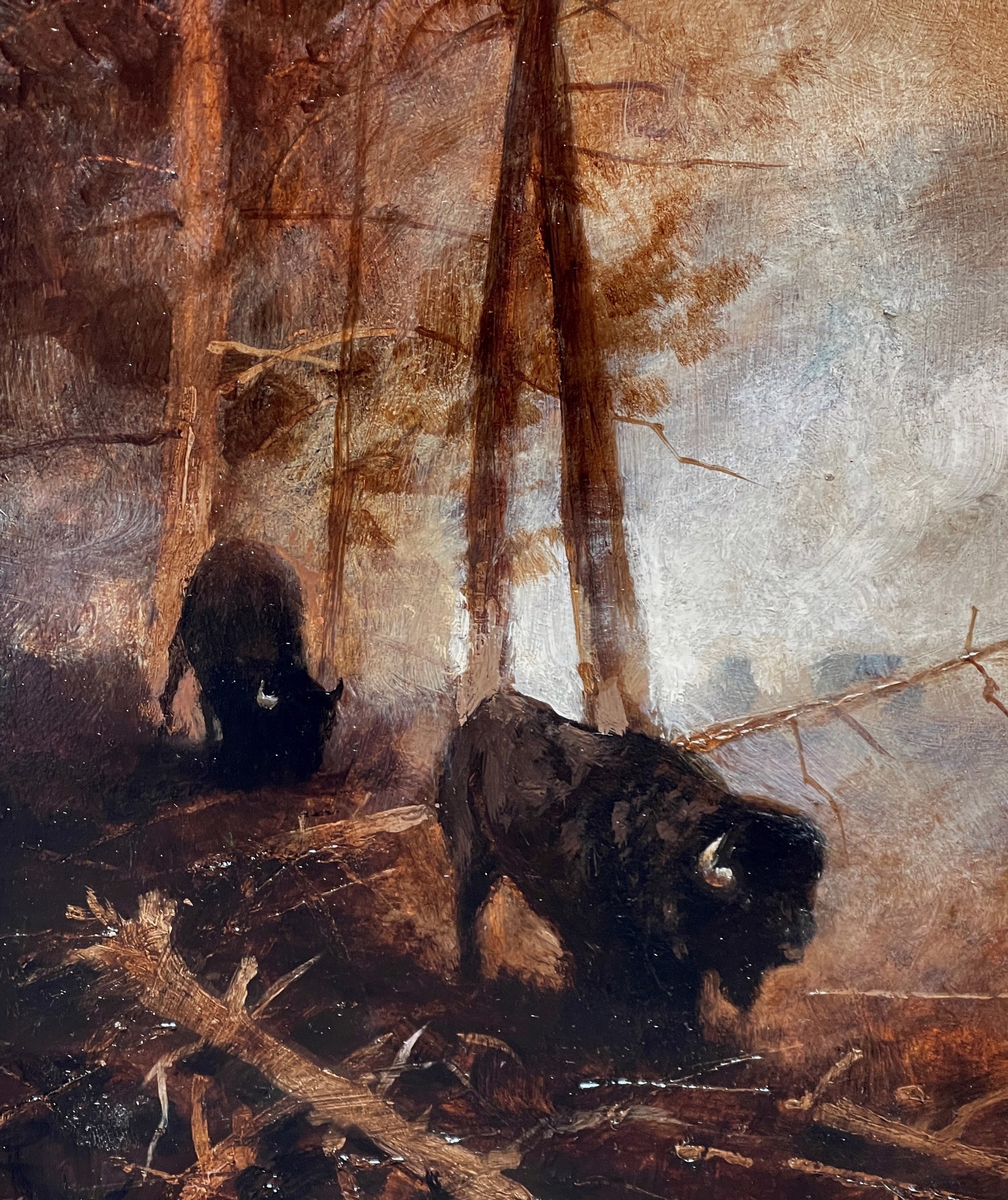 A painting of two bison in a wooded area in the woods.