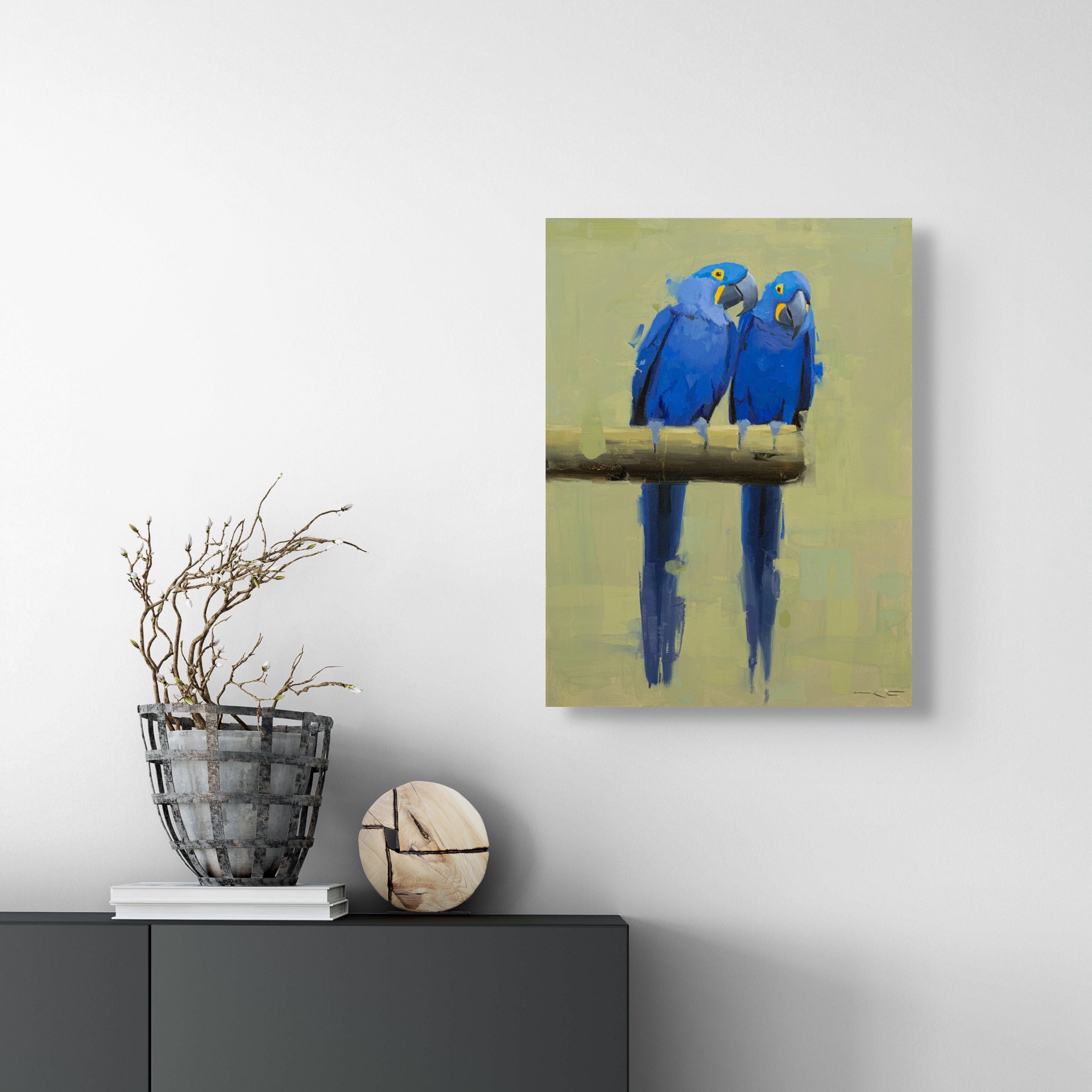 Two vivid blue parrots perch on a branch, their reflections mirrored in the water below.