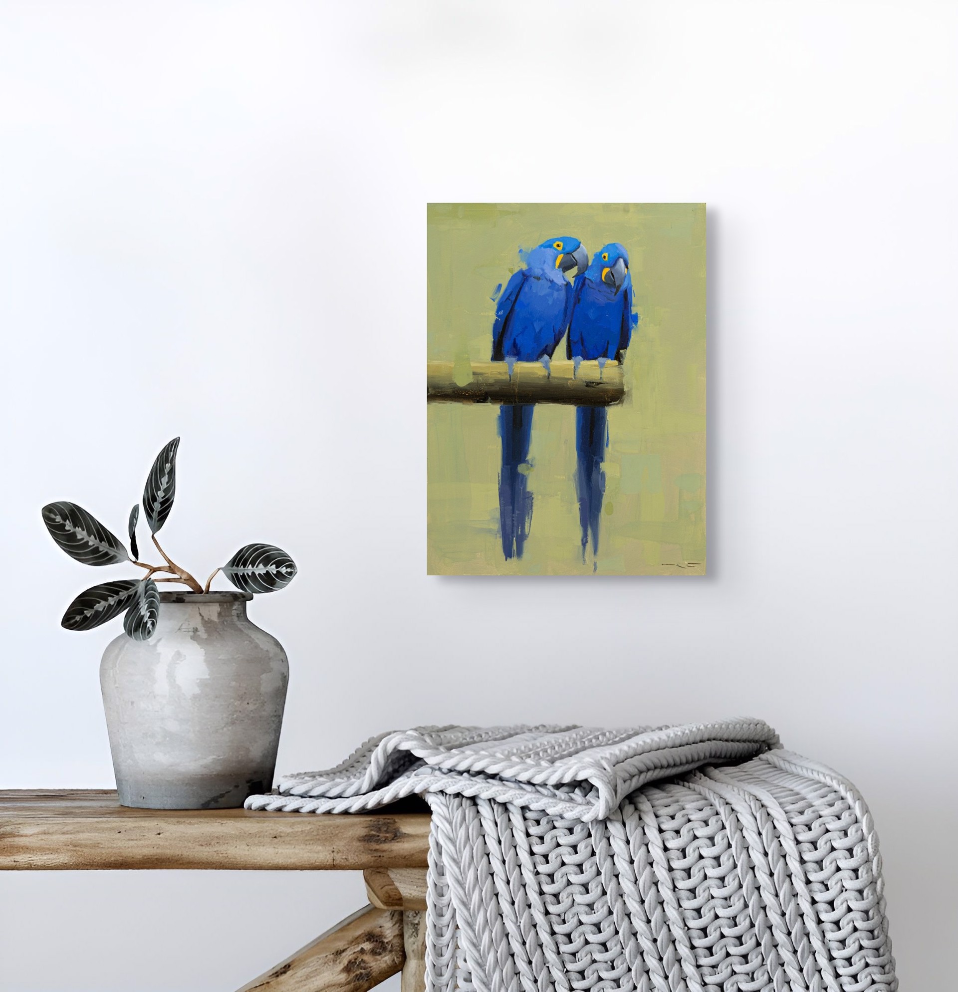 Two vivid blue parrots perch on a branch, their reflections mirrored in the water below.
