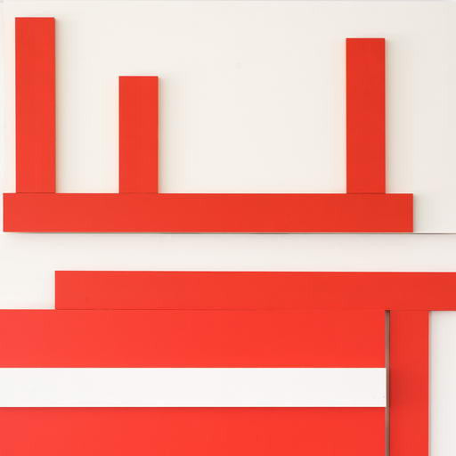 A red and white wall hanging on a white wall.