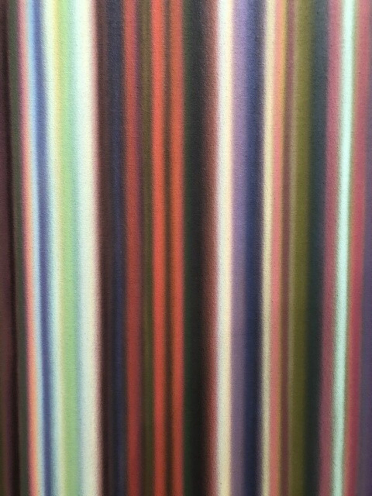 A colorful abstract piece featuring vertical stripes in a rainbow palette.