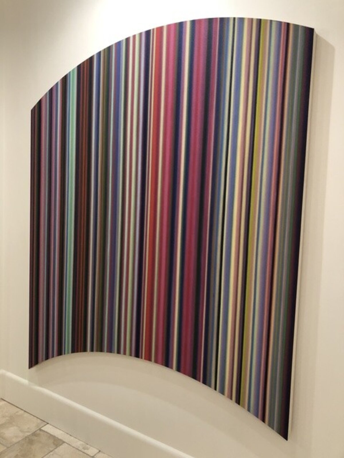 A colorful abstract piece featuring vertical stripes in a rainbow palette.