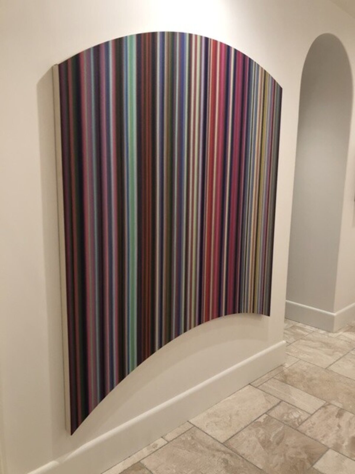 A colorful abstract piece featuring vertical stripes in a rainbow palette.