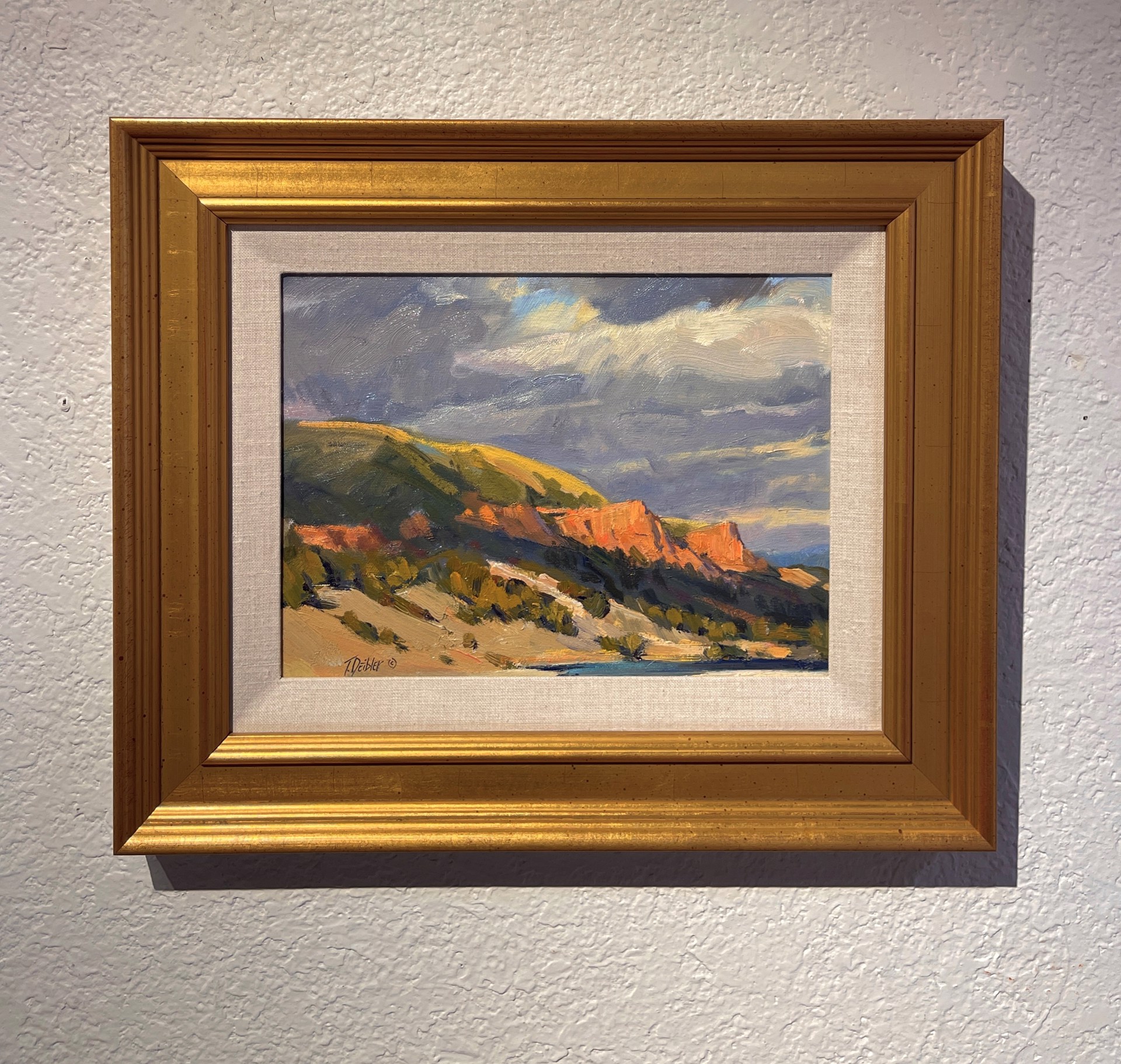 A painting of a landscape with mountains in the background.