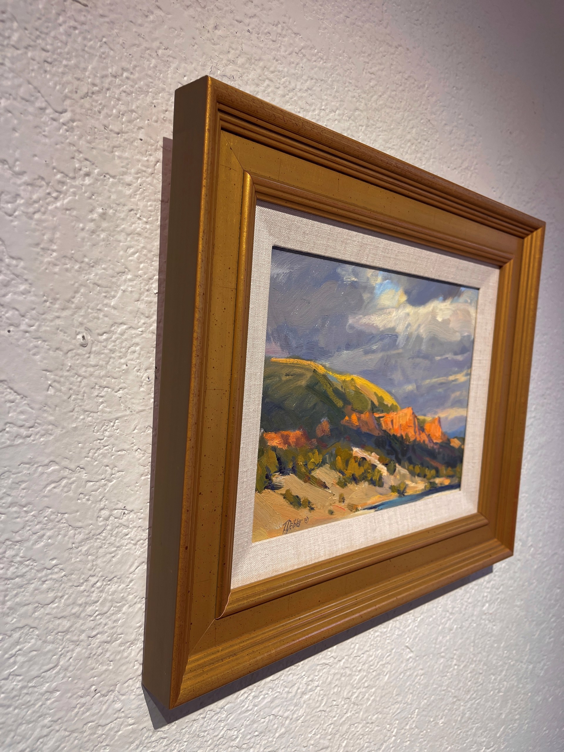 A painting of a landscape with mountains in the background.