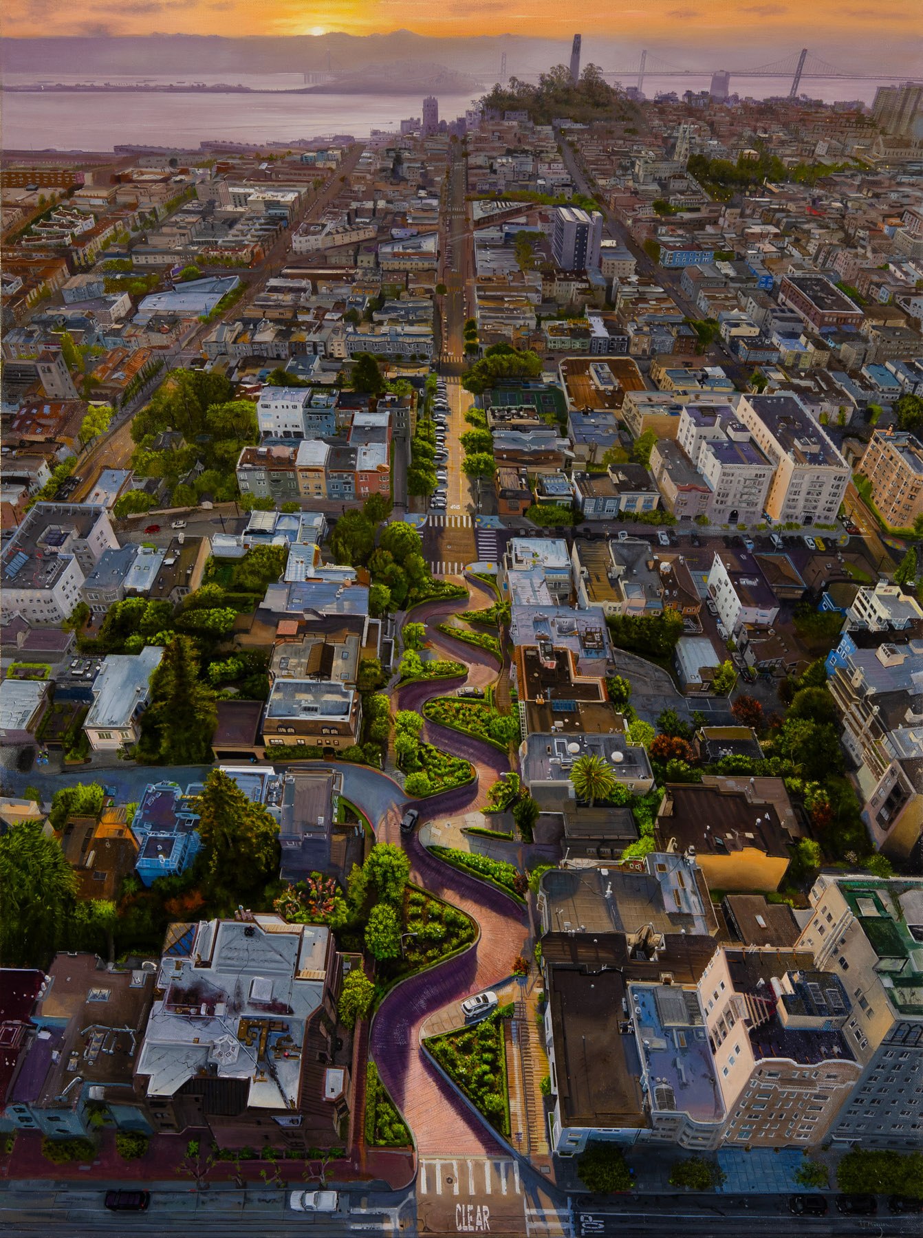 A view of a city from the top of a hill.