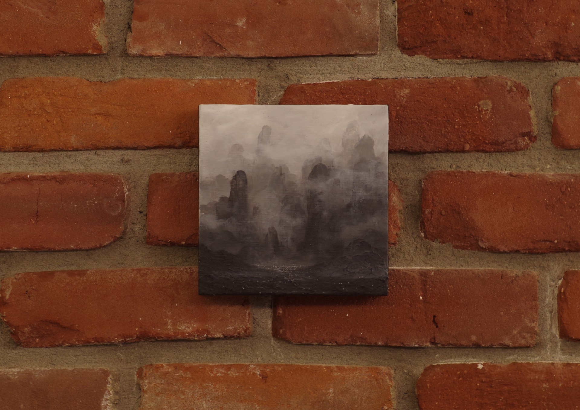 A black and white painting of a mountain landscape.