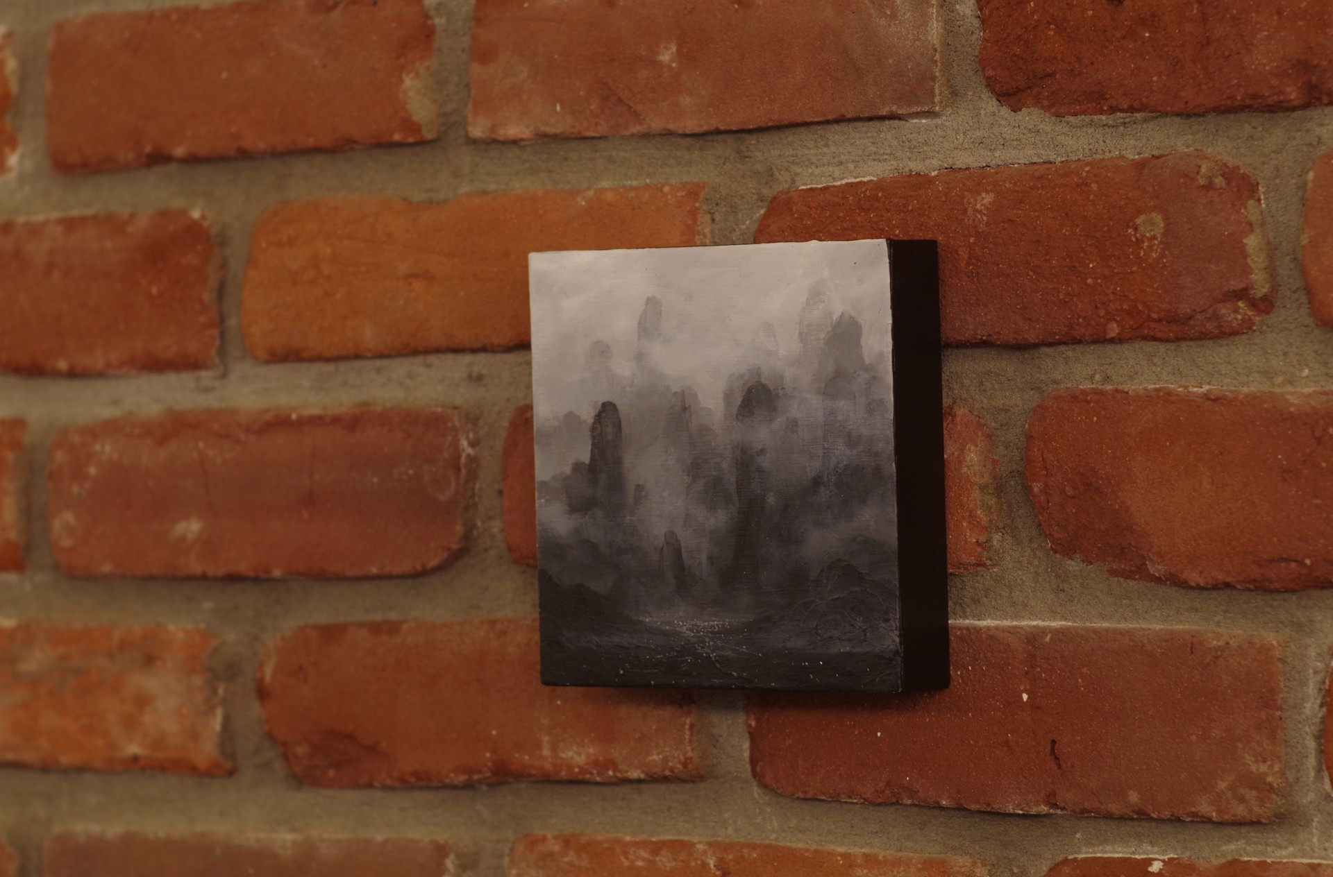 A black and white painting of a mountain landscape.