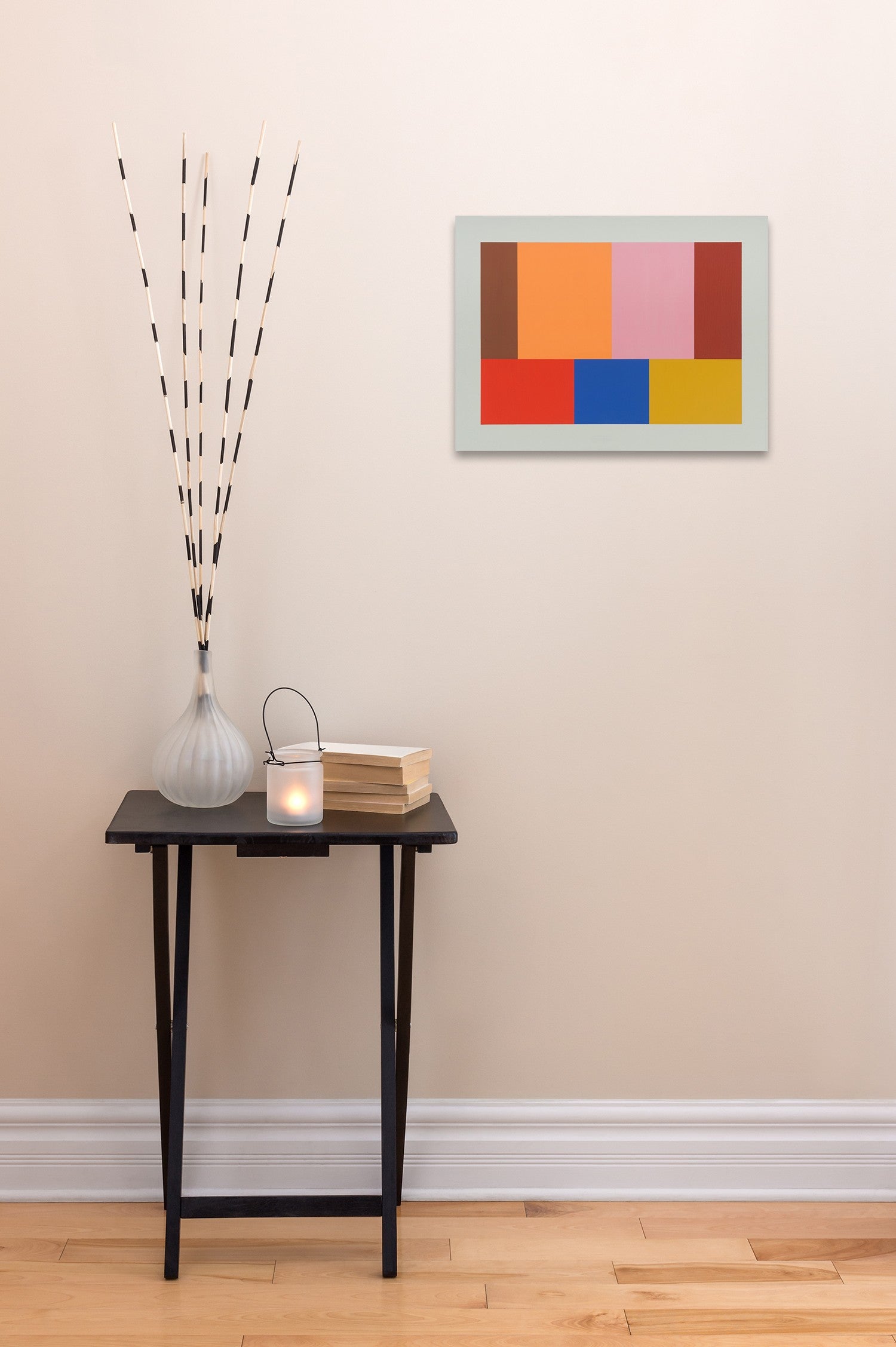 A picture of a colorful painting on a white wall.