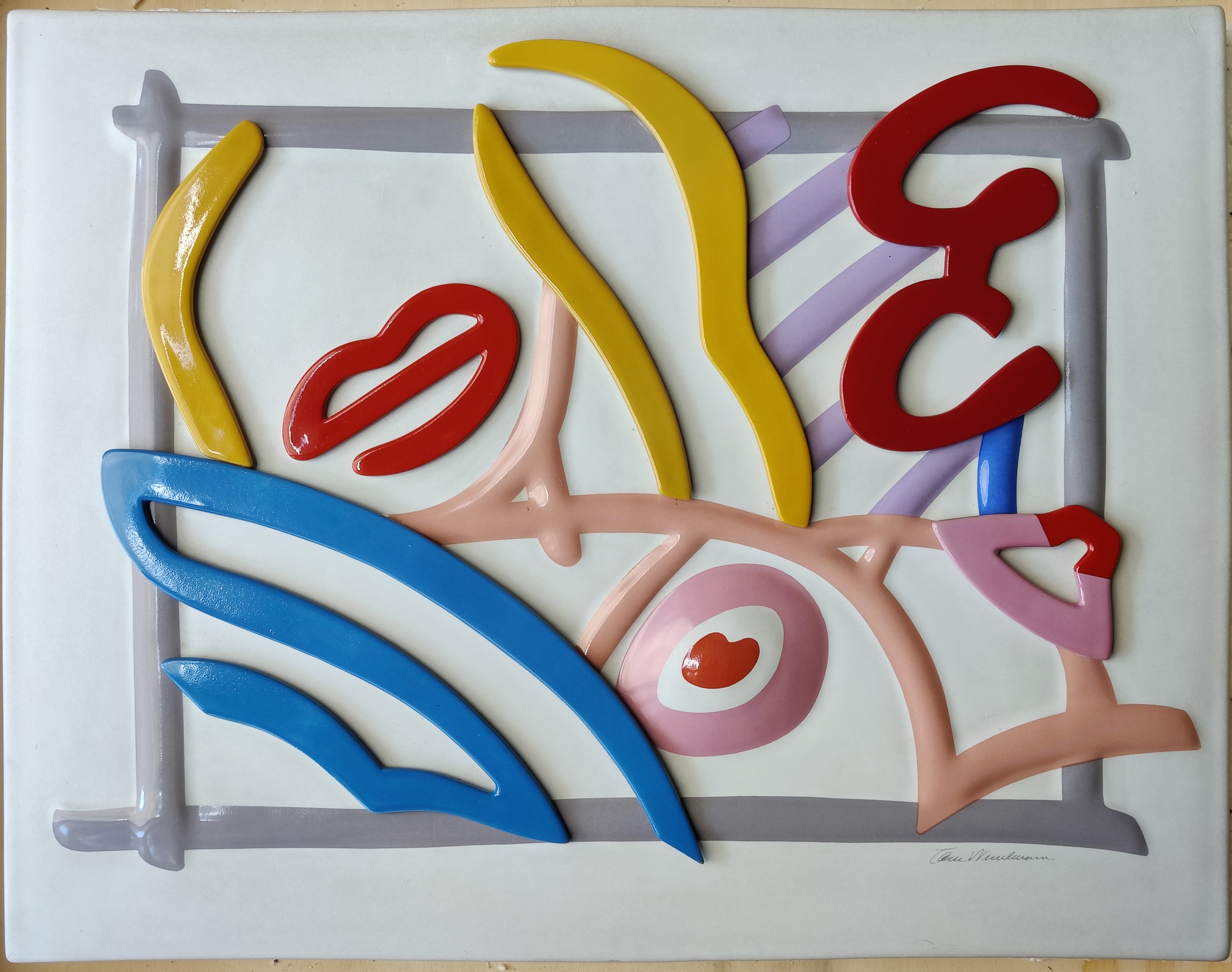 A ceramic tile with a colorful abstract design on it.