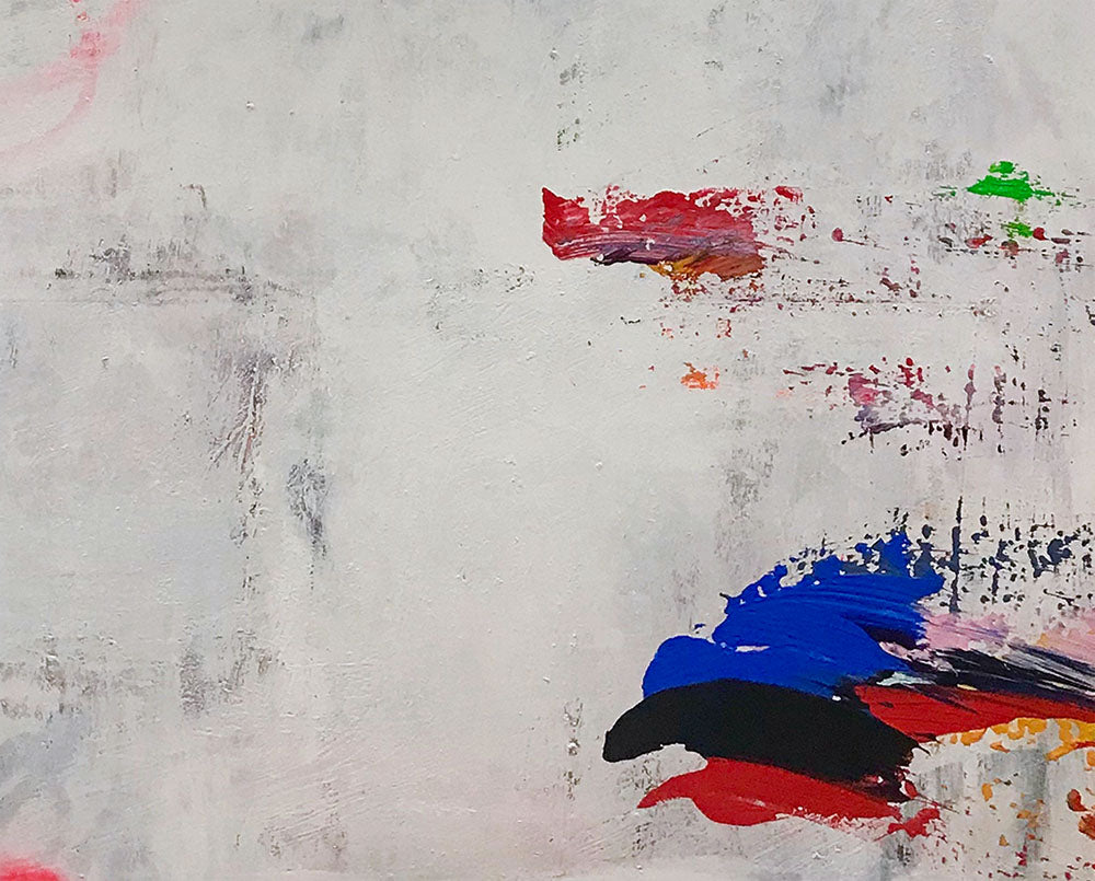 A painting on a white wall with red, blue, and yellow paint.