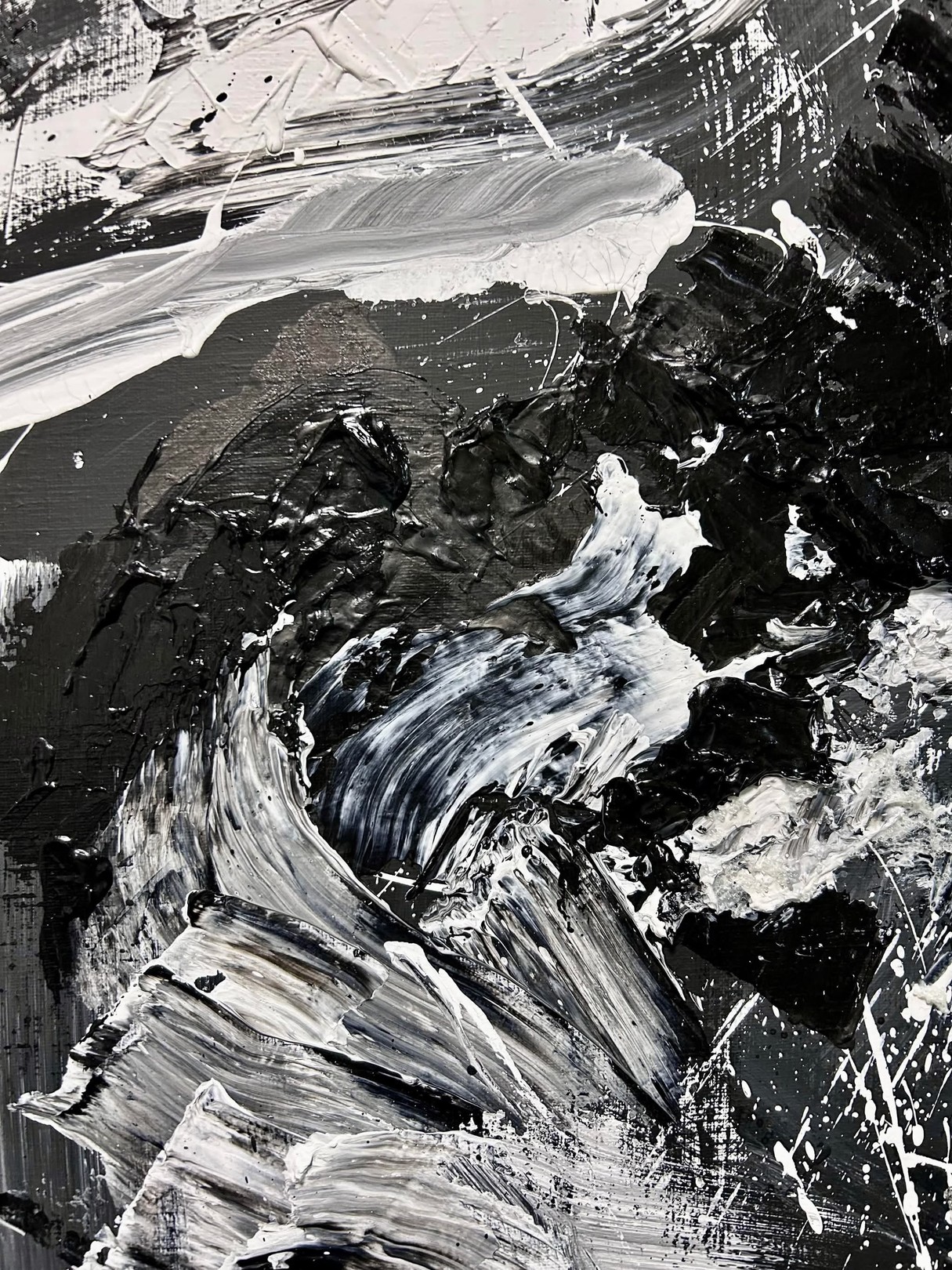 A dynamic black and white abstract painting featuring bold brushstrokes, splatters, and textured layers.