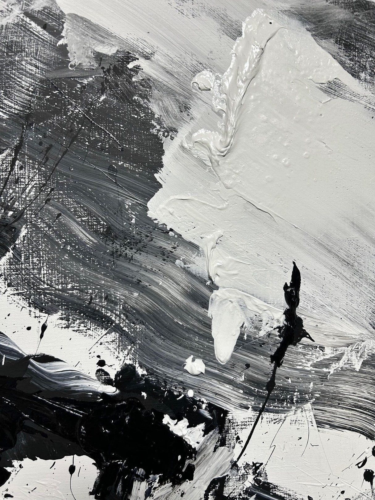 A dynamic black and white abstract painting featuring bold brushstrokes, splatters, and textured layers.