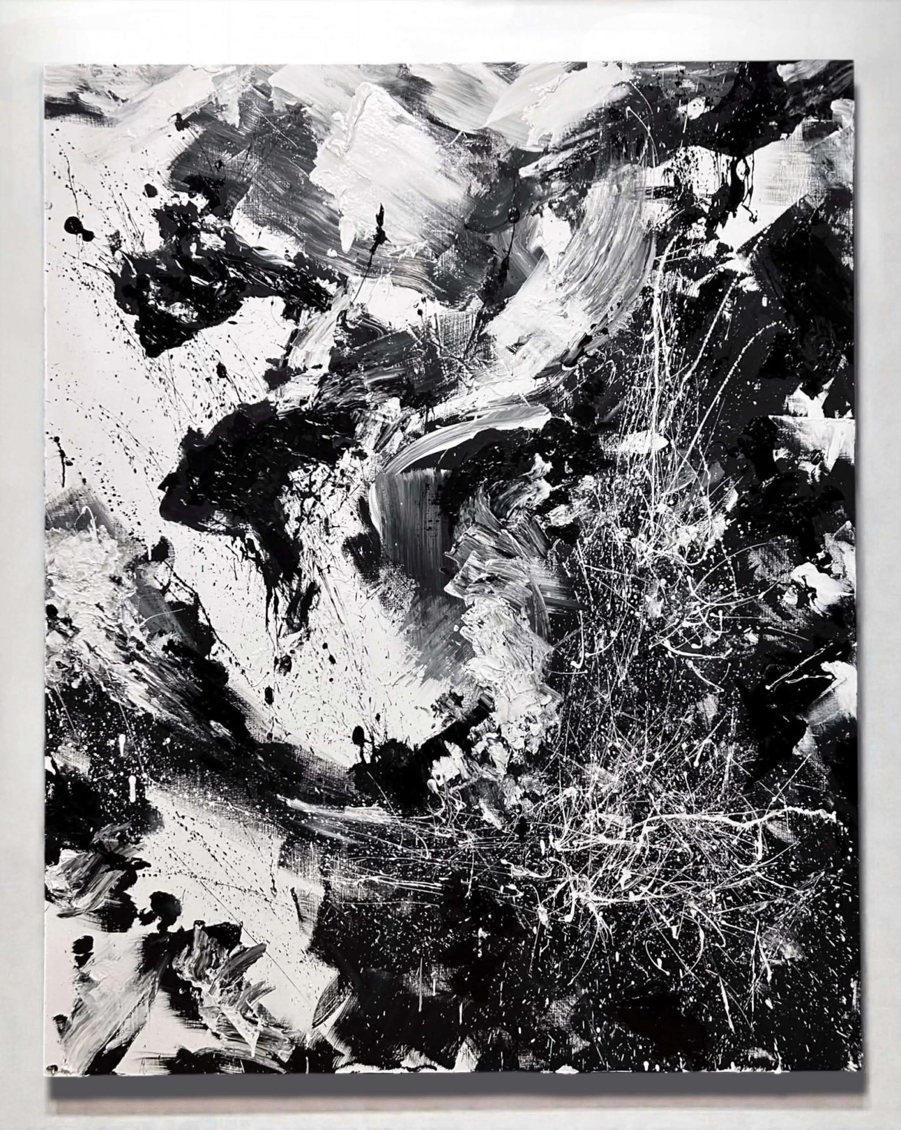 A dynamic black and white abstract painting featuring bold brushstrokes, splatters, and textured layers.