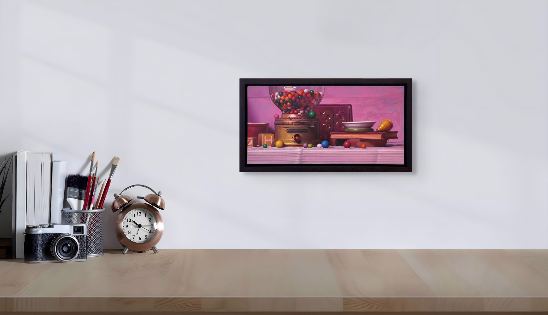A colorful still life featuring a vintage gumball machine, books, and scattered spheres against a soft pink backdrop.