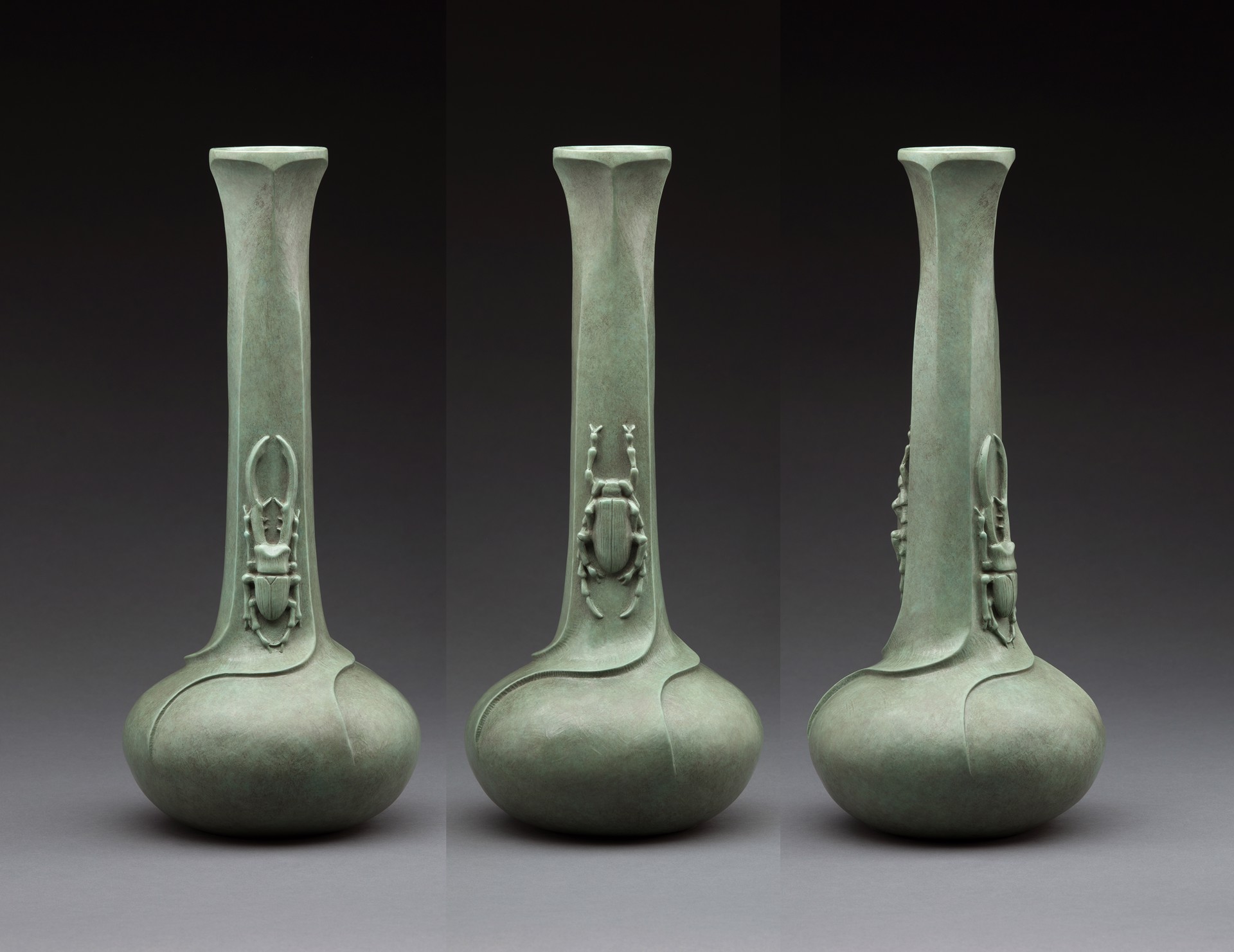 A group of three green vases sitting next to each other.
