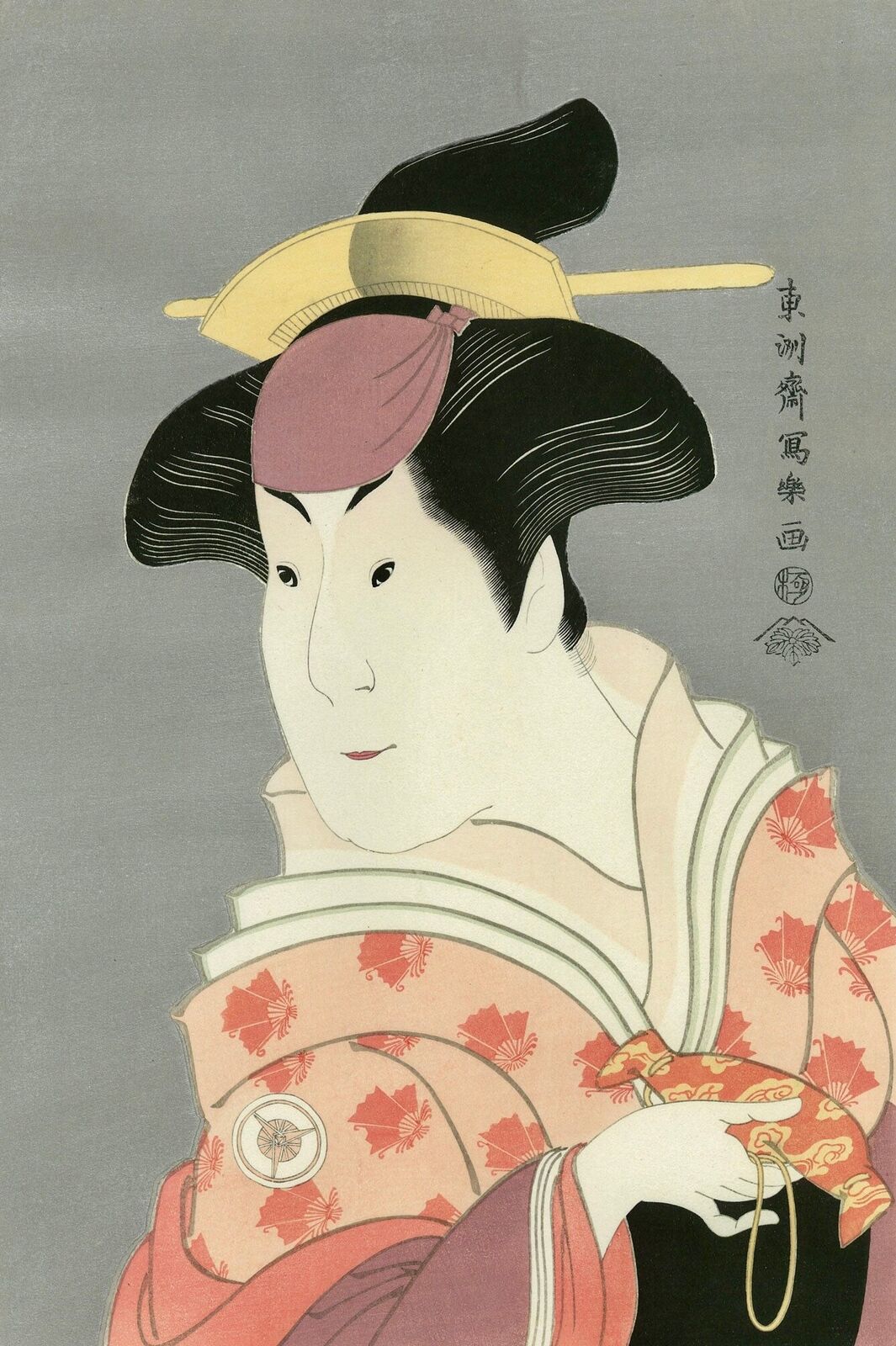 A woman in a kimono with a fan in her hand.