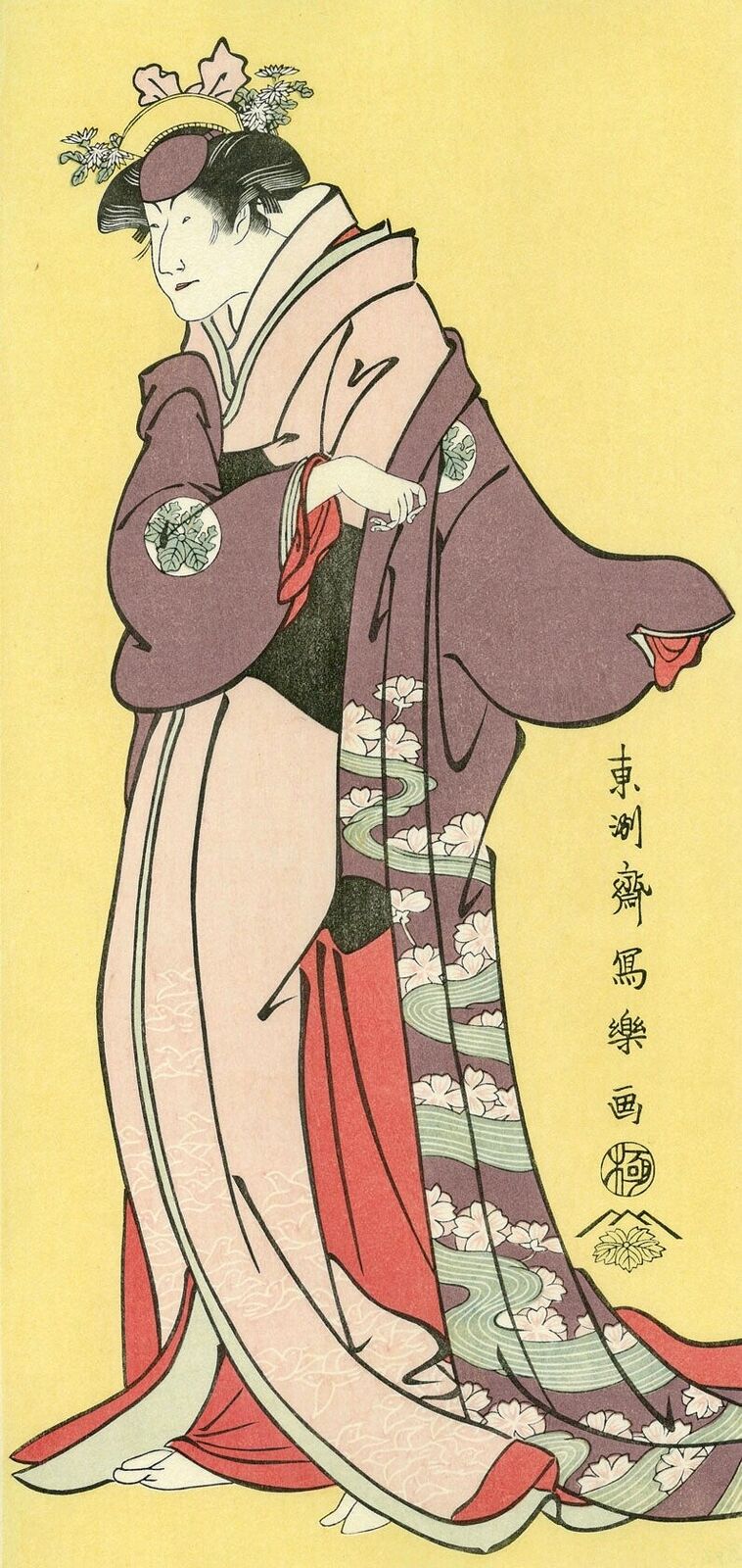 A woman in a kimono is standing in front of a yellow background.