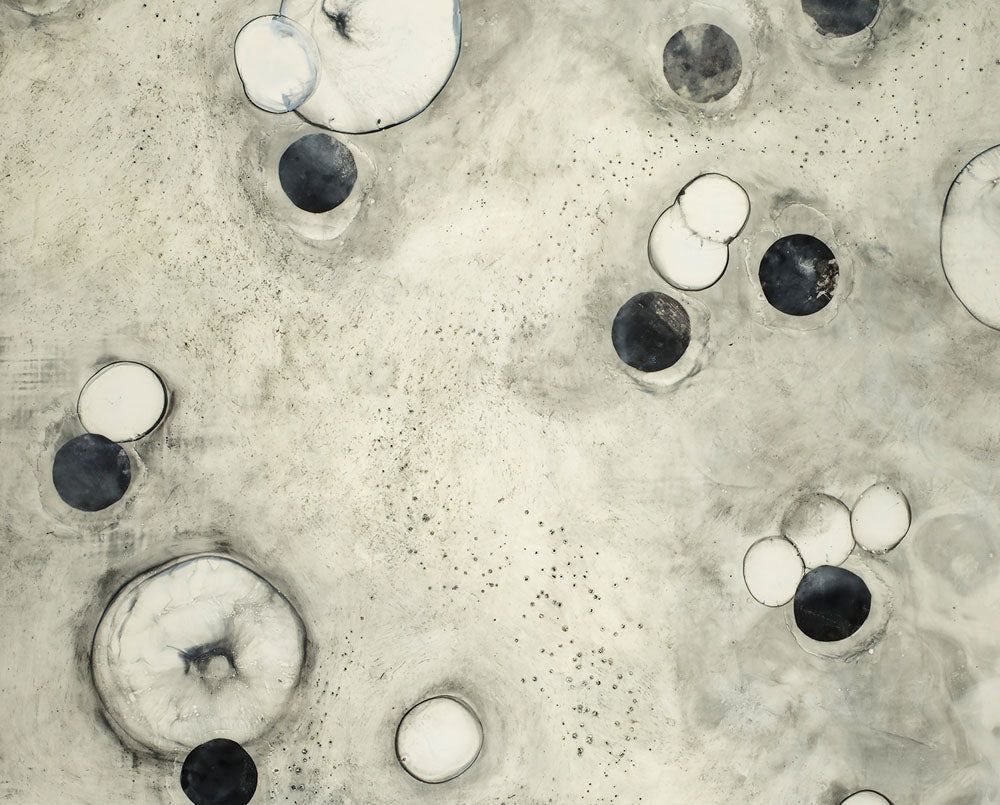 A black and white painting of circles on a white background.