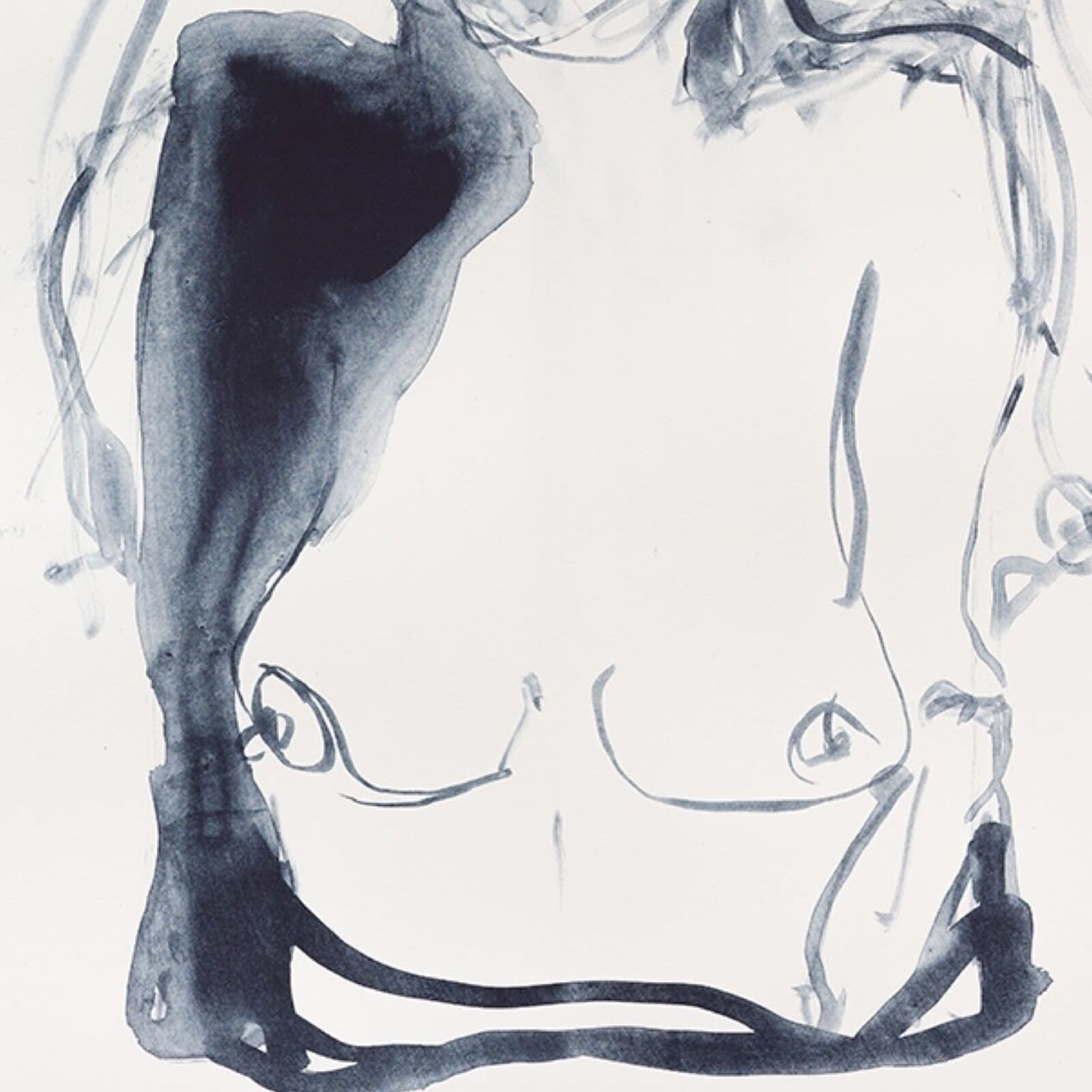 A black and white drawing of a woman's face on a white wall.