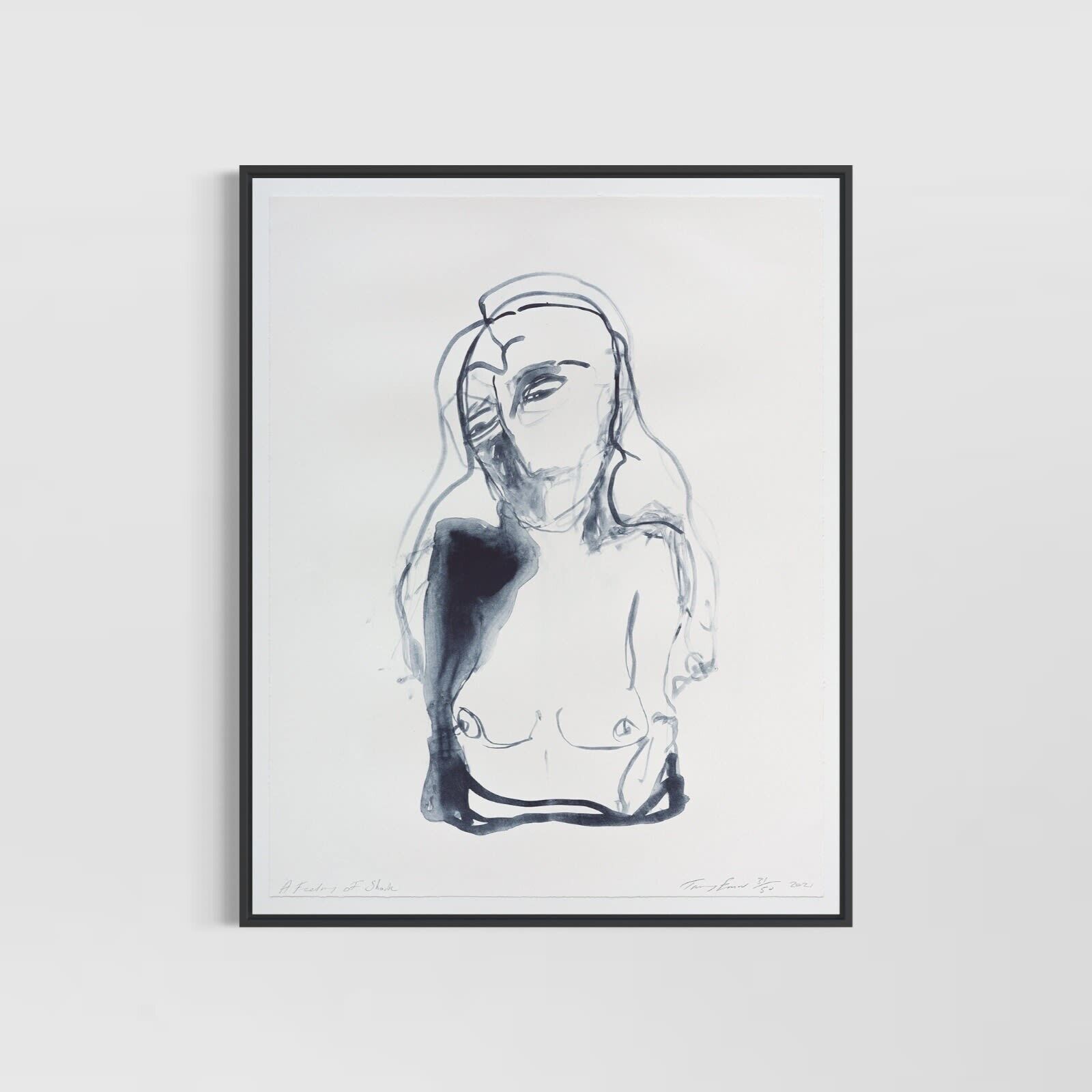 A black and white drawing of a woman's face on a white wall.