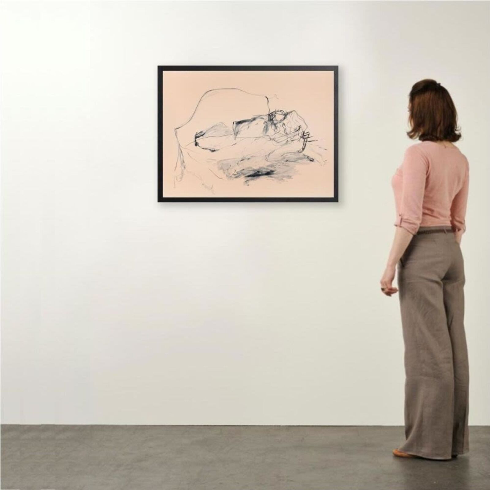 A minimalist charcoal sketch of a reclining figure on a pale peach background.