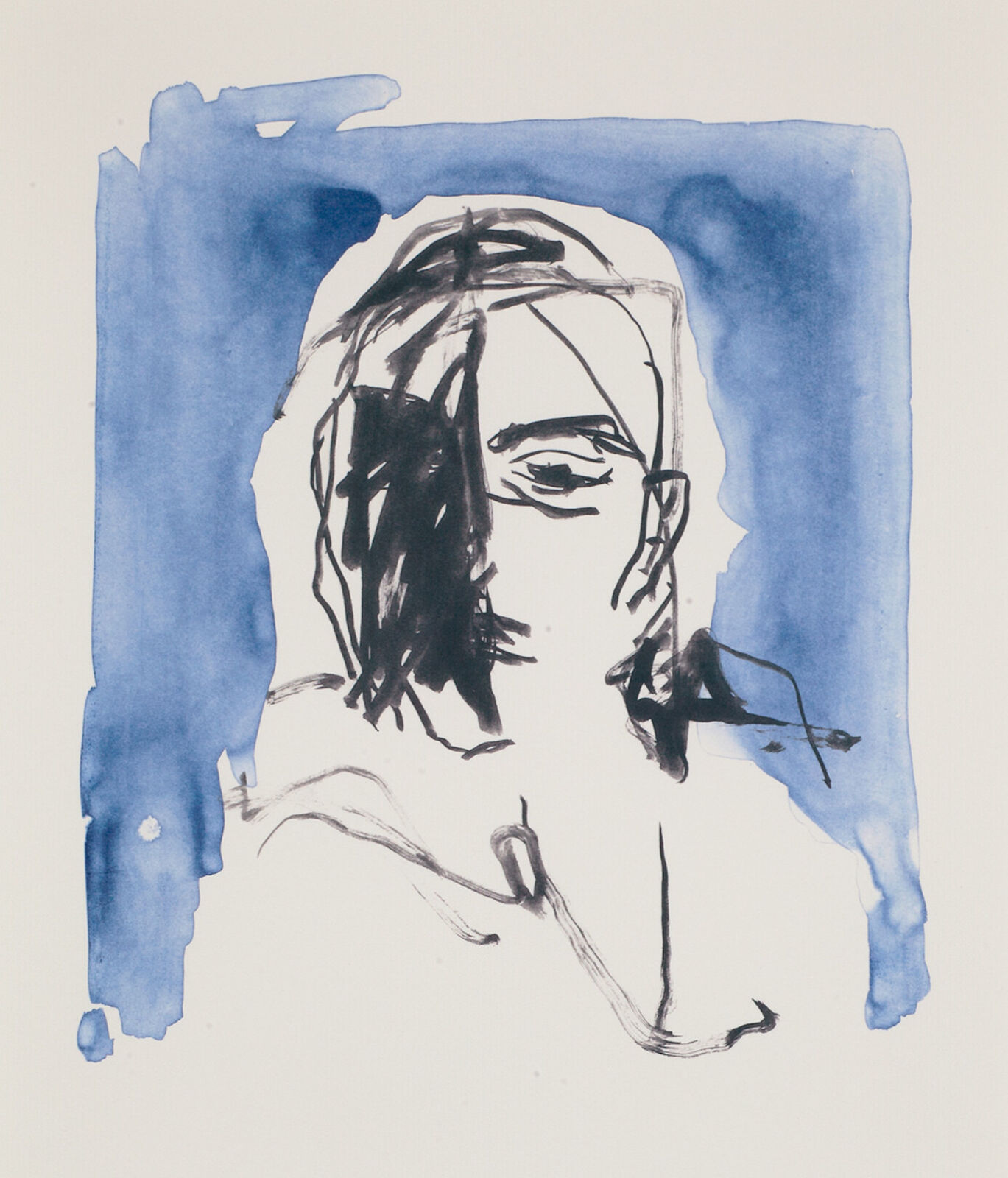 A person in a pink top and wide-leg trousers stands observing a blue-toned portrait on a white gallery wall.